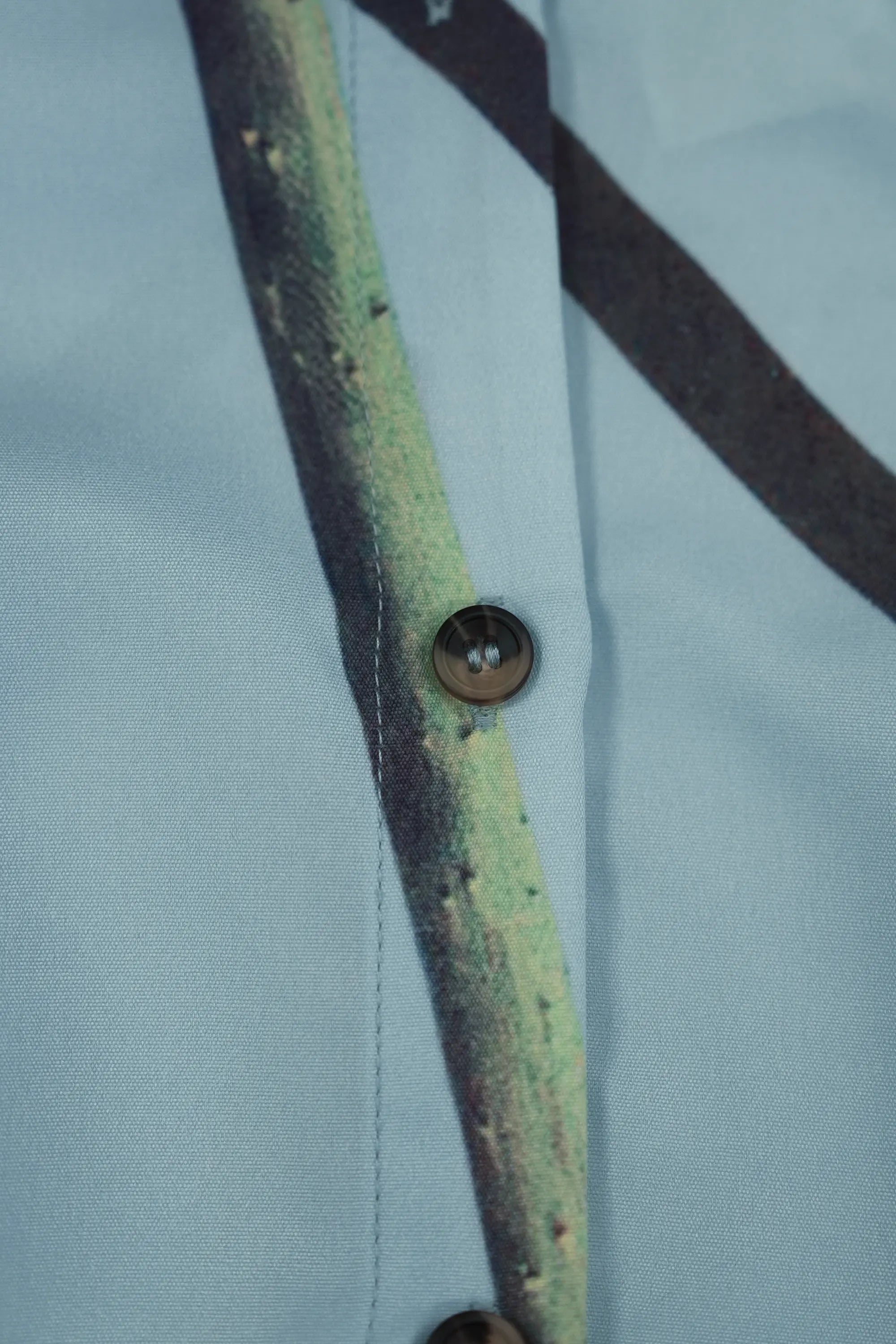 ABIDE printed mini dress button closure and placement print detail (close-up)