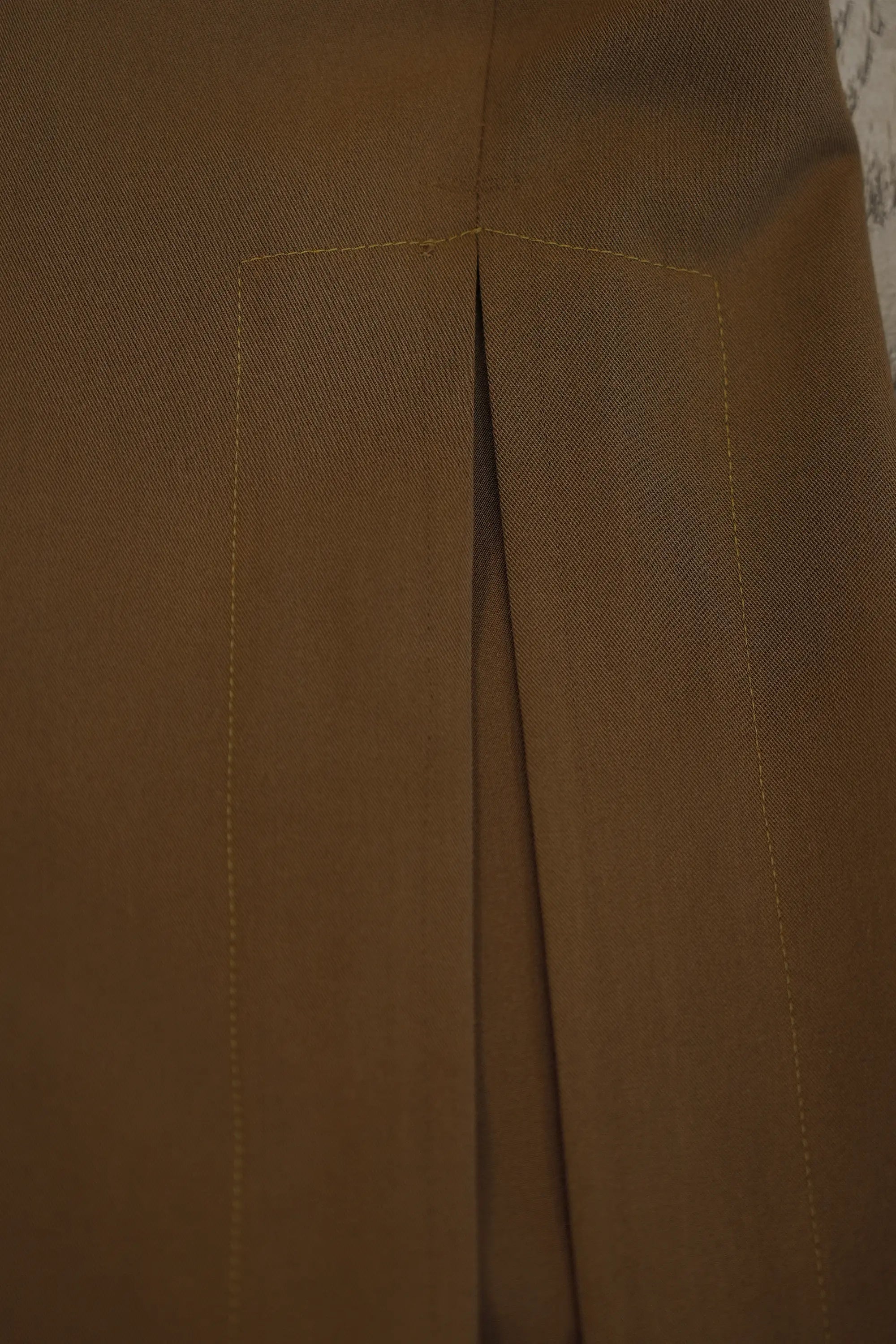 Close-up of ABIDE brown pants with a visible seam