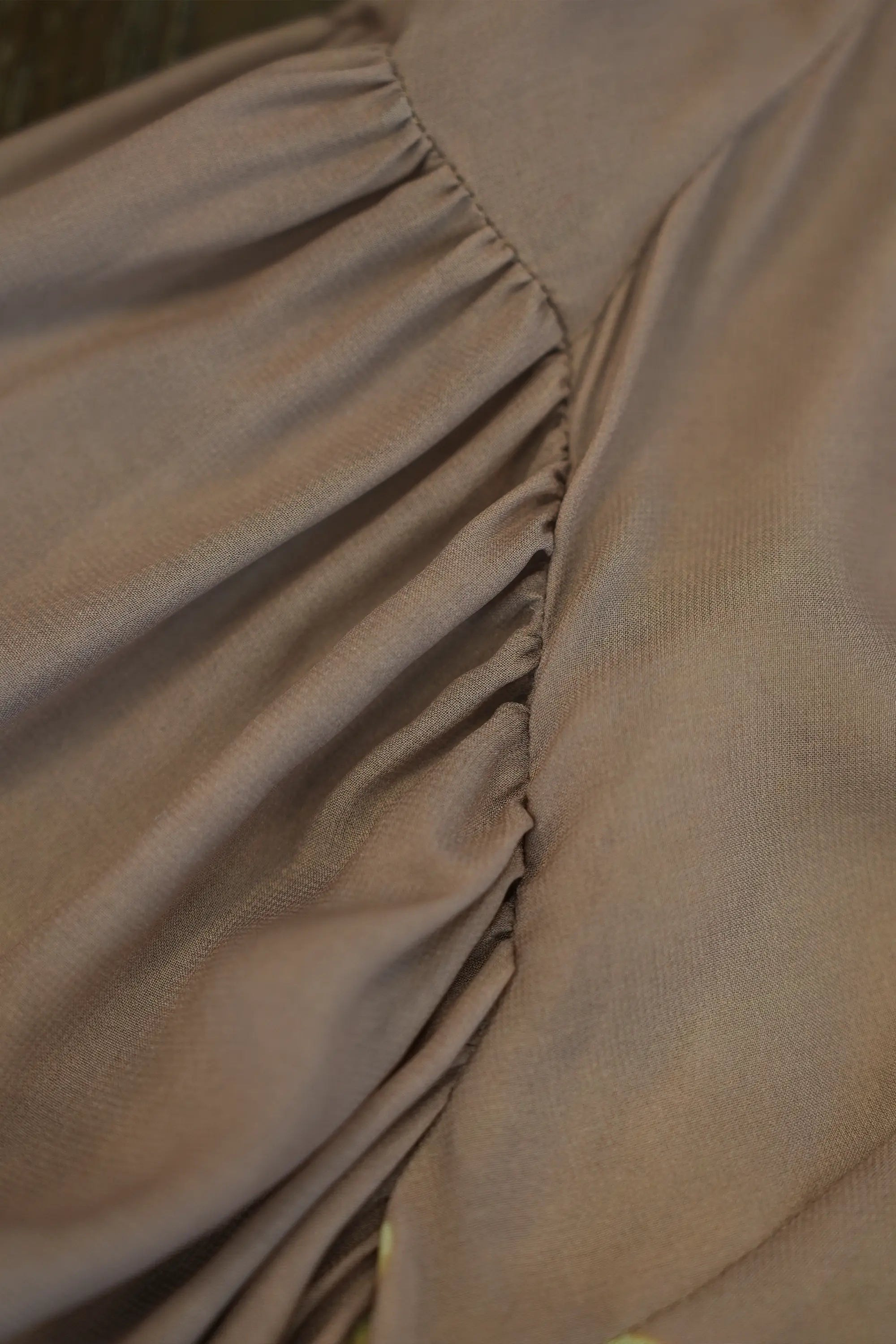 ABIDE blouse sleeve gathering seam detail with soft drape fabric (close-up)
