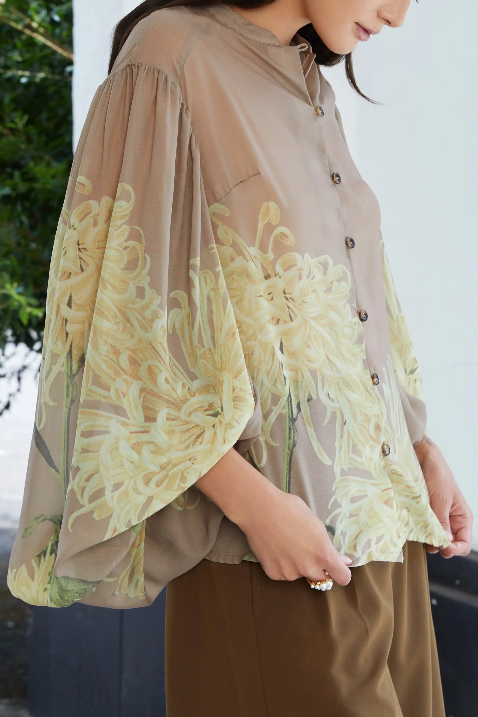 ABIDE sheer floral blouse voluminous pleated sleeve detail with print placement (close-up)
