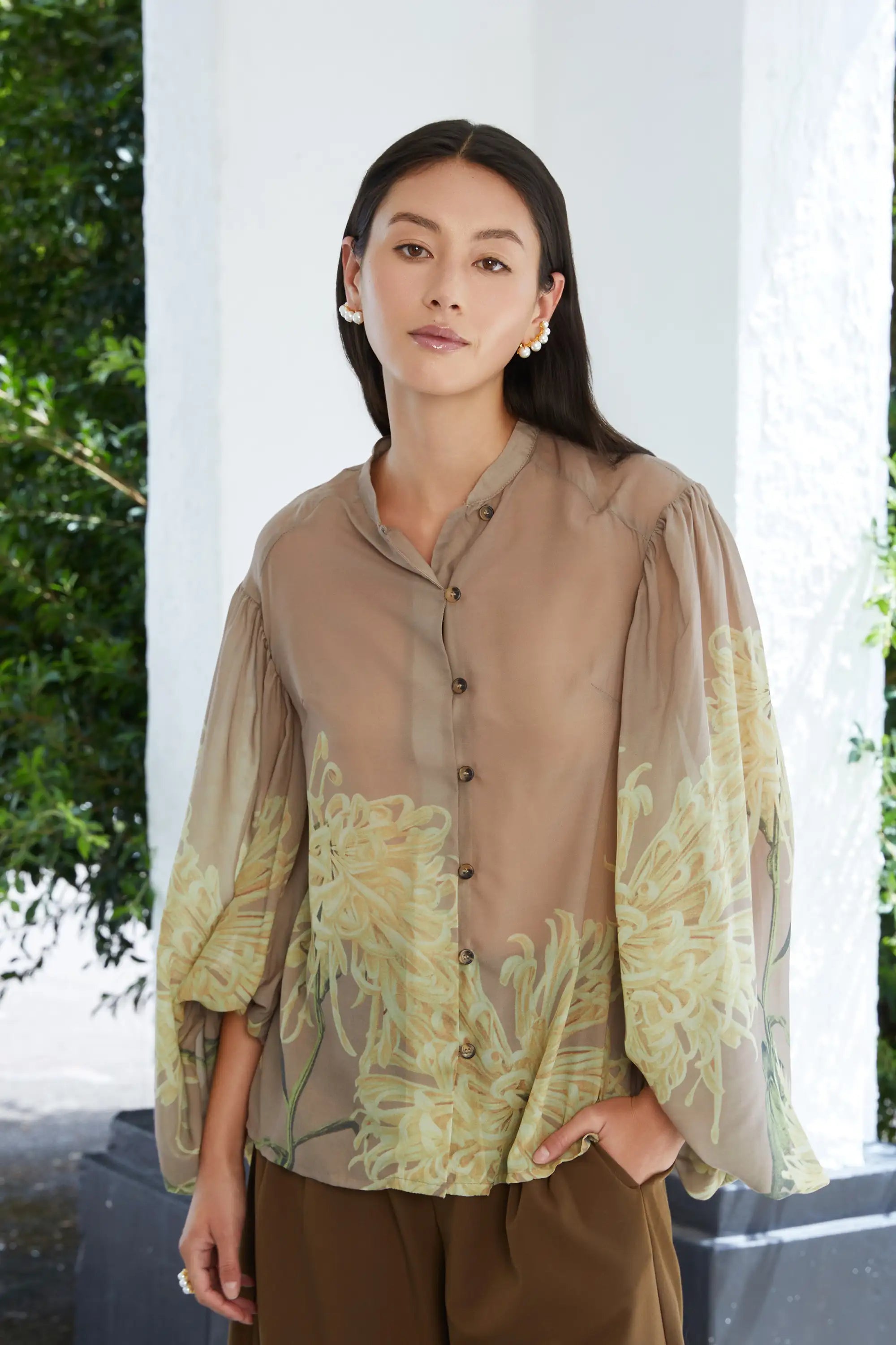 Woman wearing ABIDE sheer floral blouse in brown tones (front view)