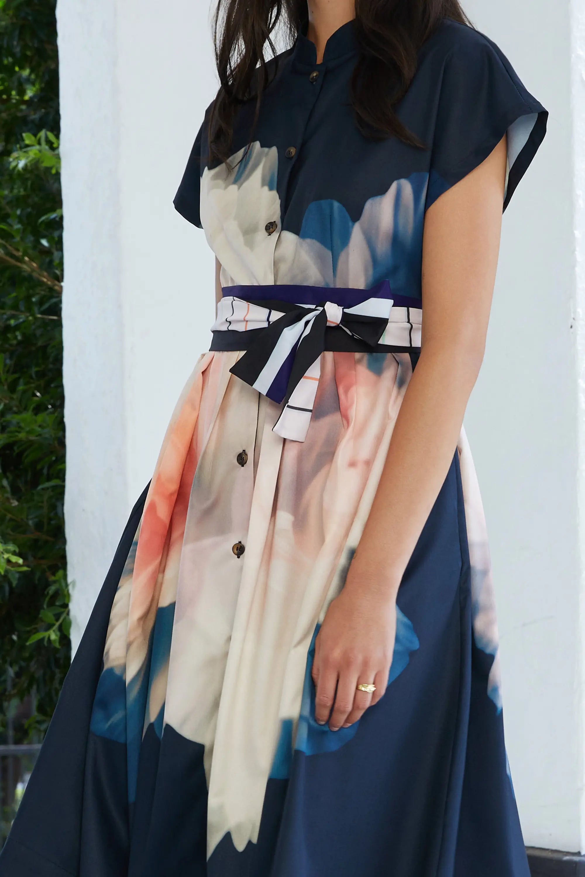ABIDE placement print midi dress side view with contrast sash belt and button front detail (close-up)