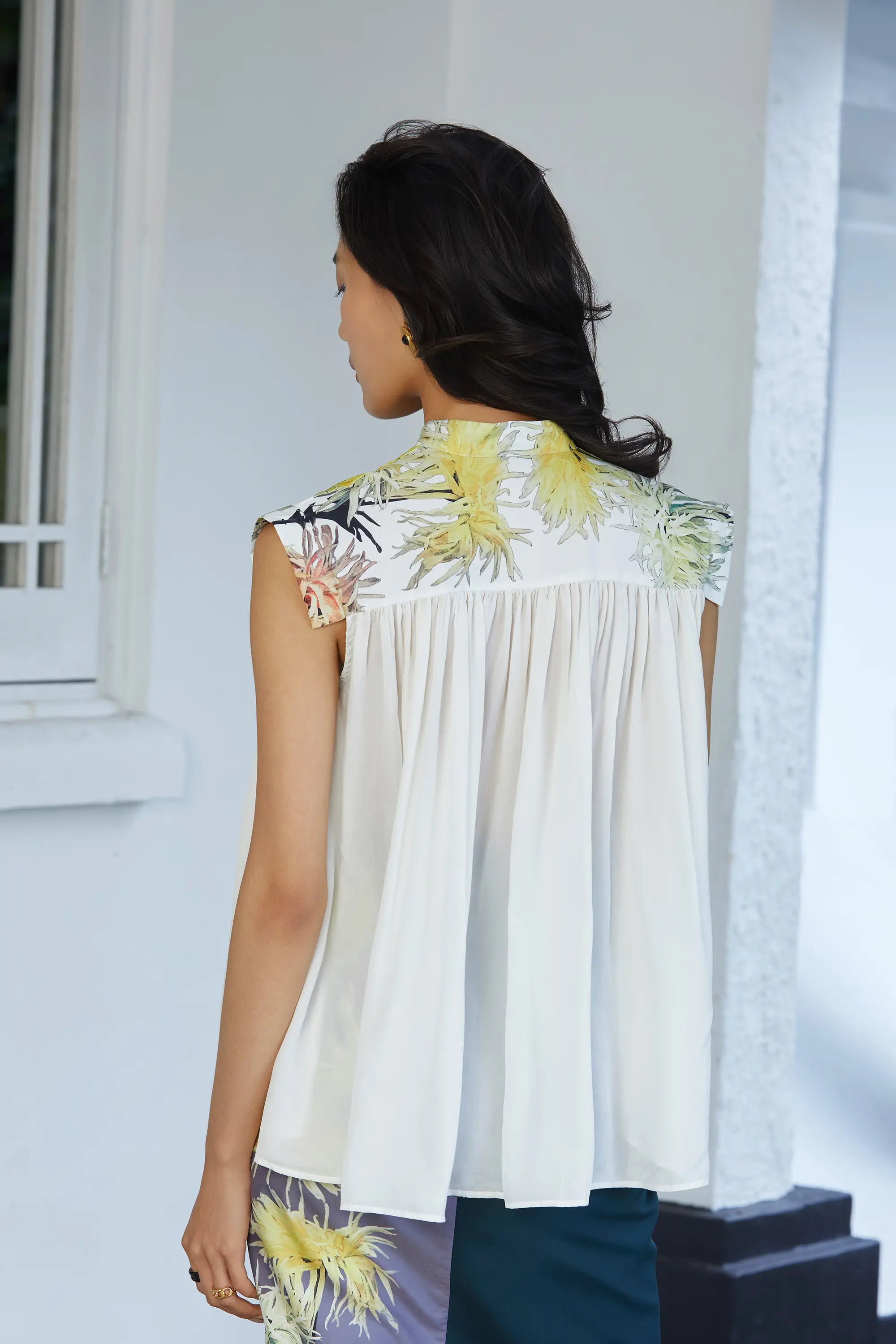 Clean, flowy back with continued soft gathers from the neckline, creating movement and ease, finished with a smooth, uninterrupted silhouette.