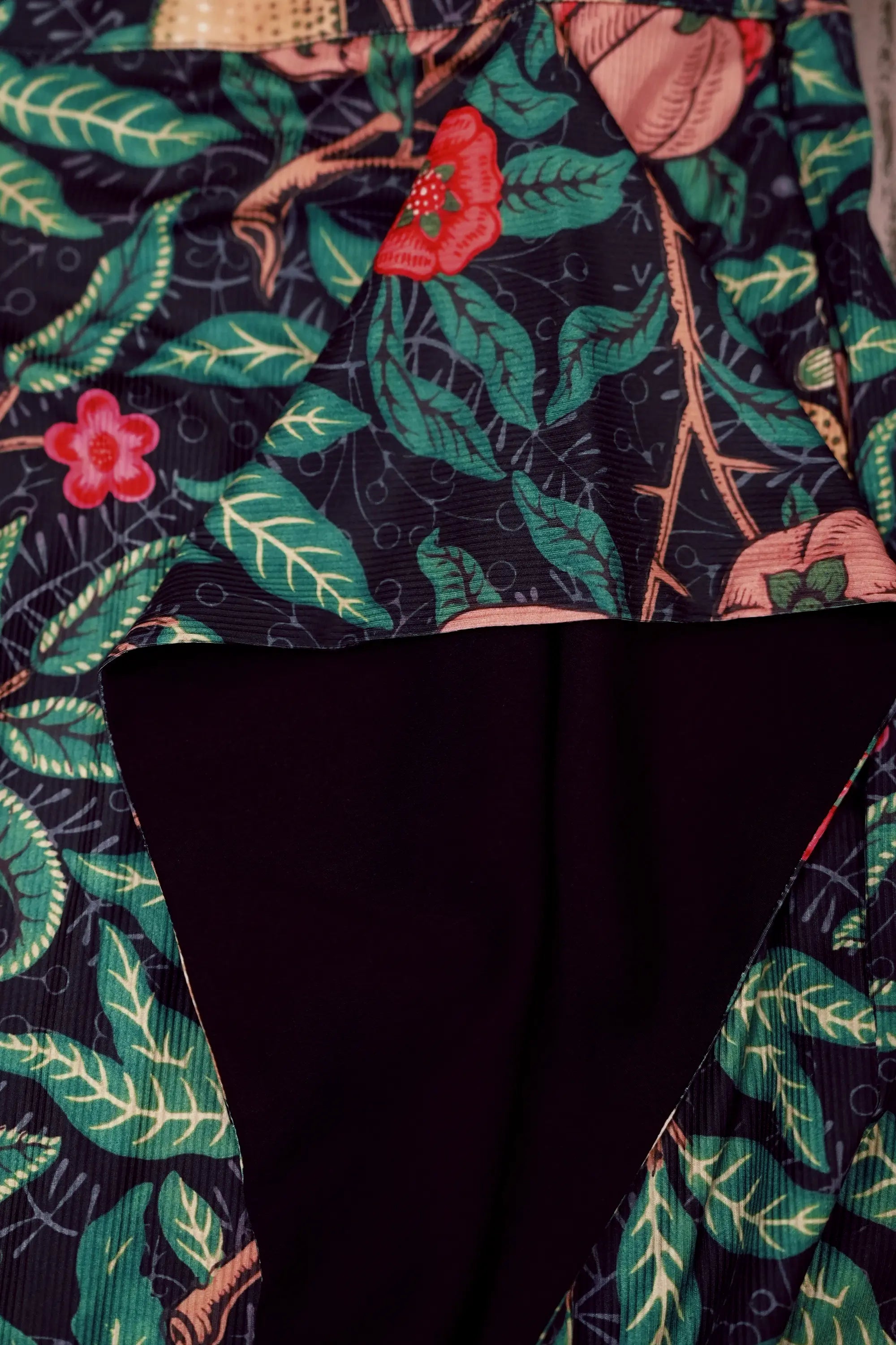 Close-up of draped side panel on Arrayed black Pomegranate print ribbed skirt