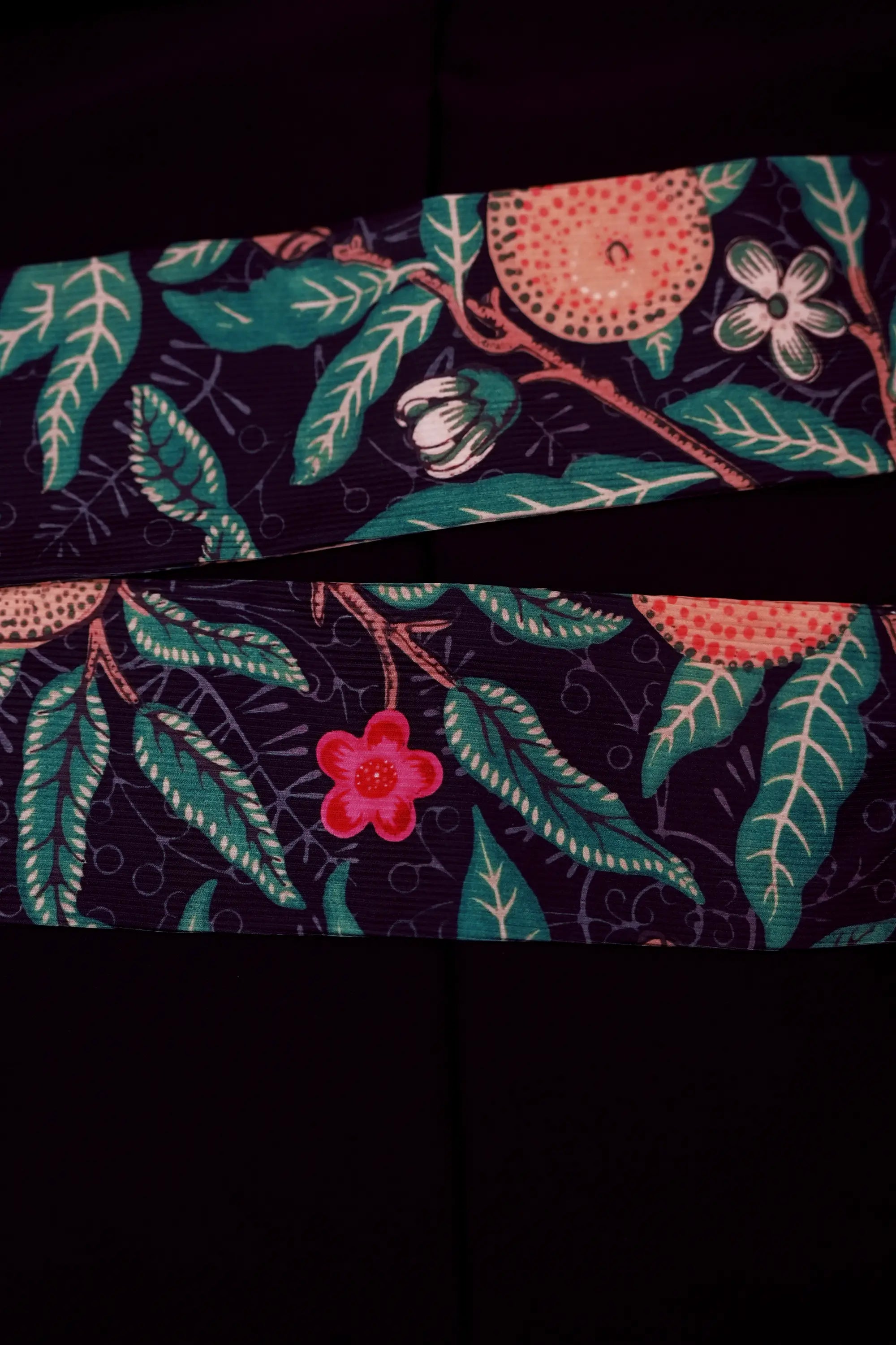 Close-up of back slit on Arrayed black Pomegranate print ribbed midi skirt