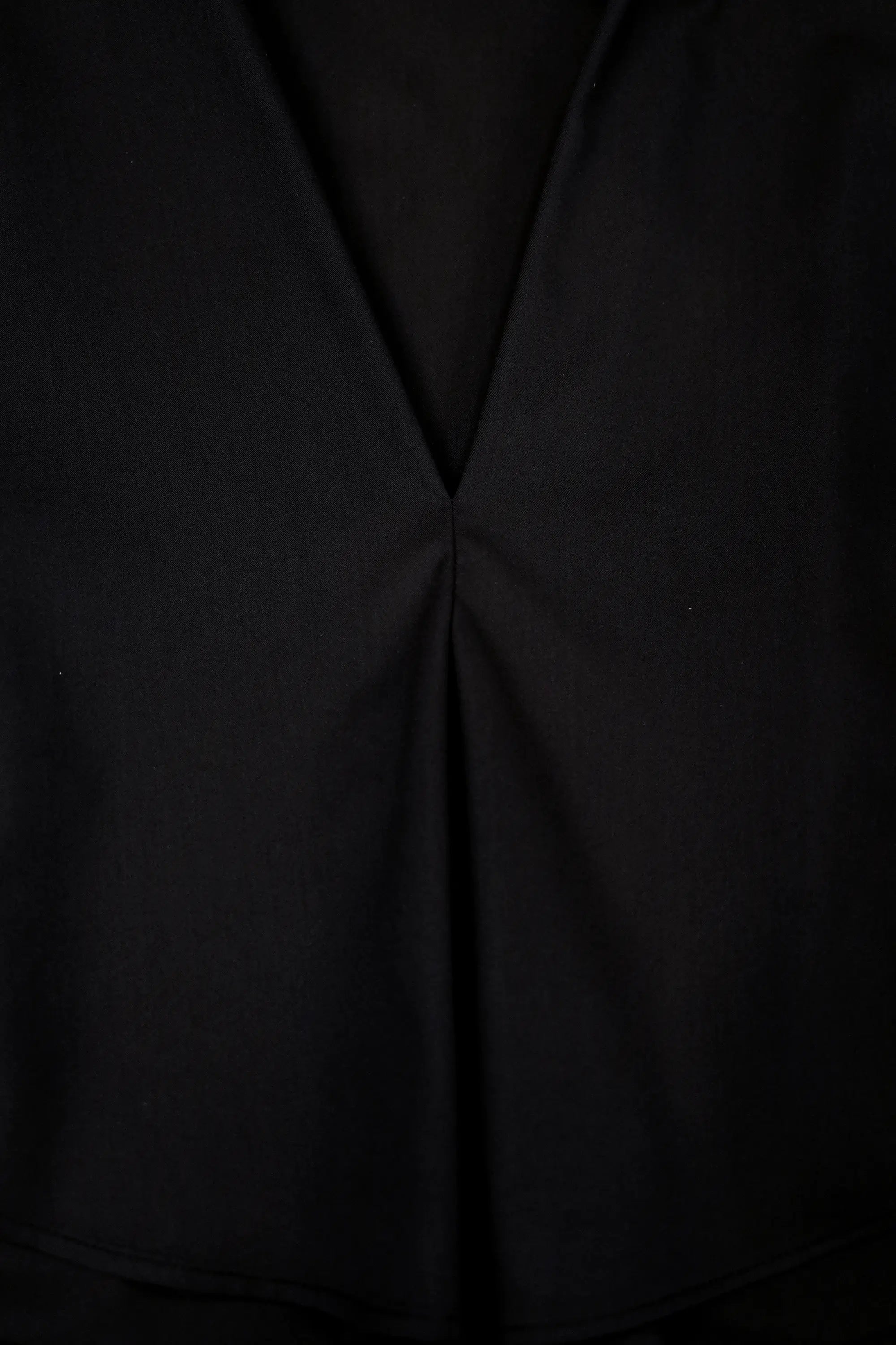 Close-up of sculpted fold detail on Arrayed black adjustable top