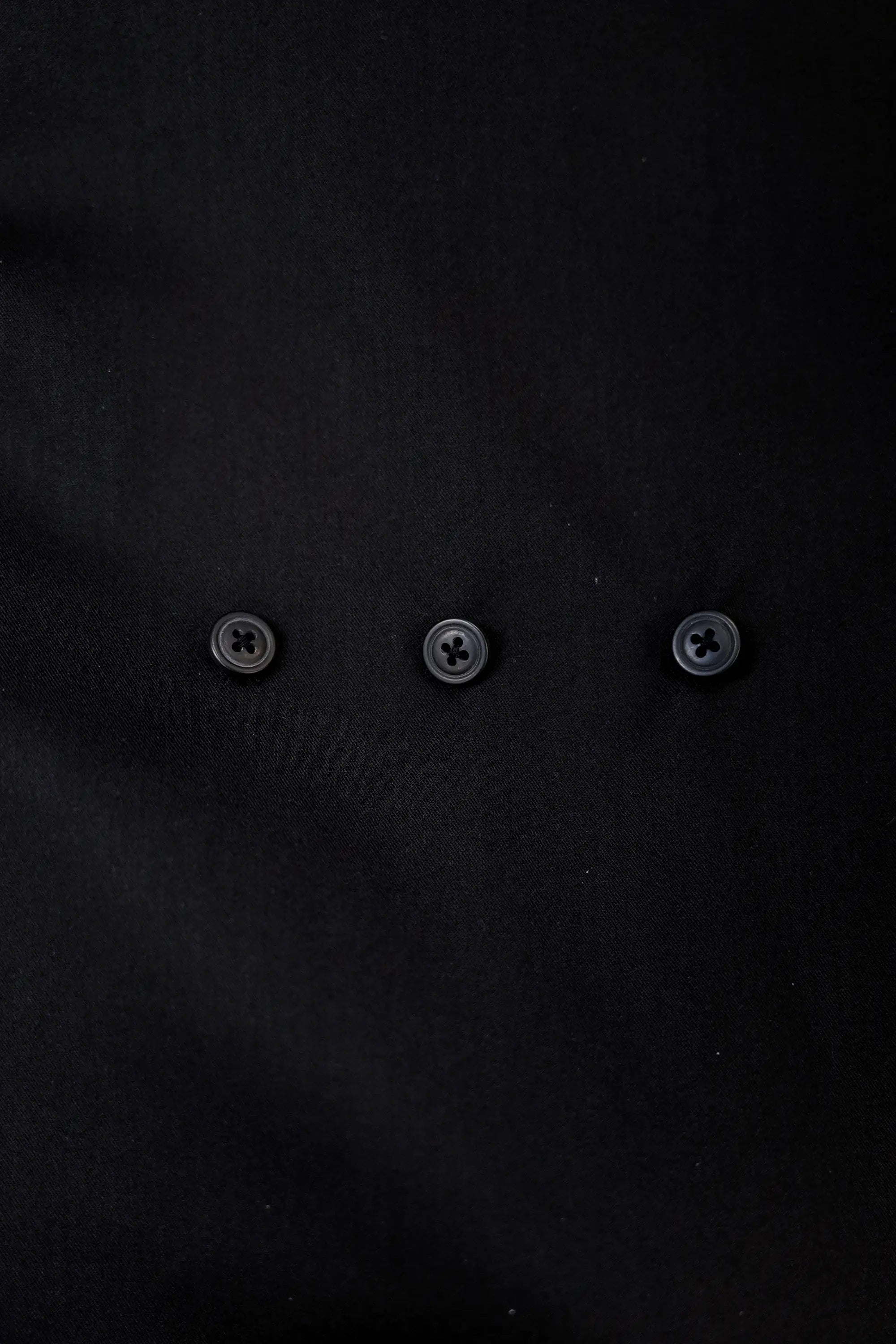 Close-up of buttons on Arrayed black adjustable top