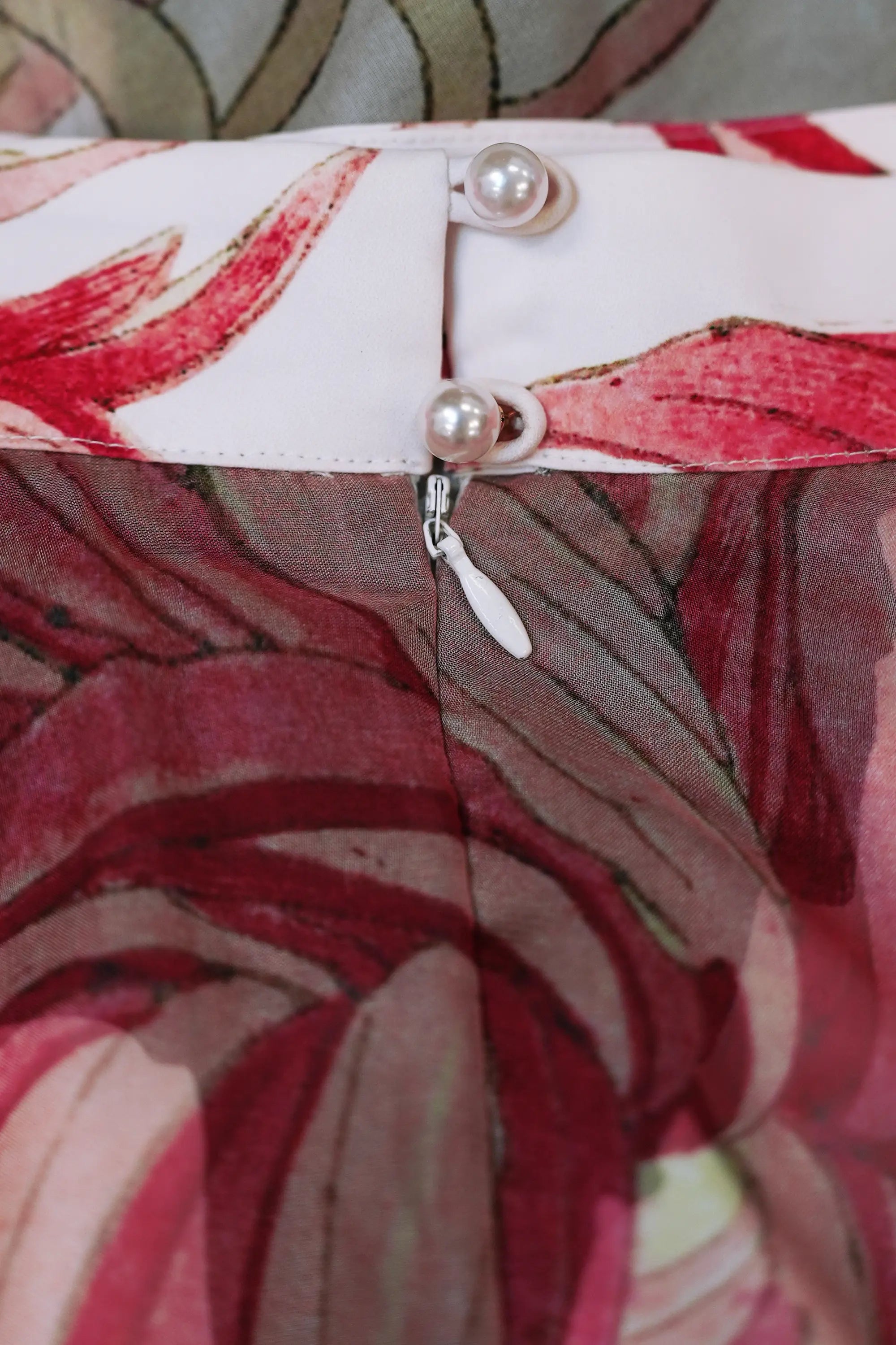 Close-up of pearl button and zip closure on Arrayed Chrysanthemum print organza piping skirt