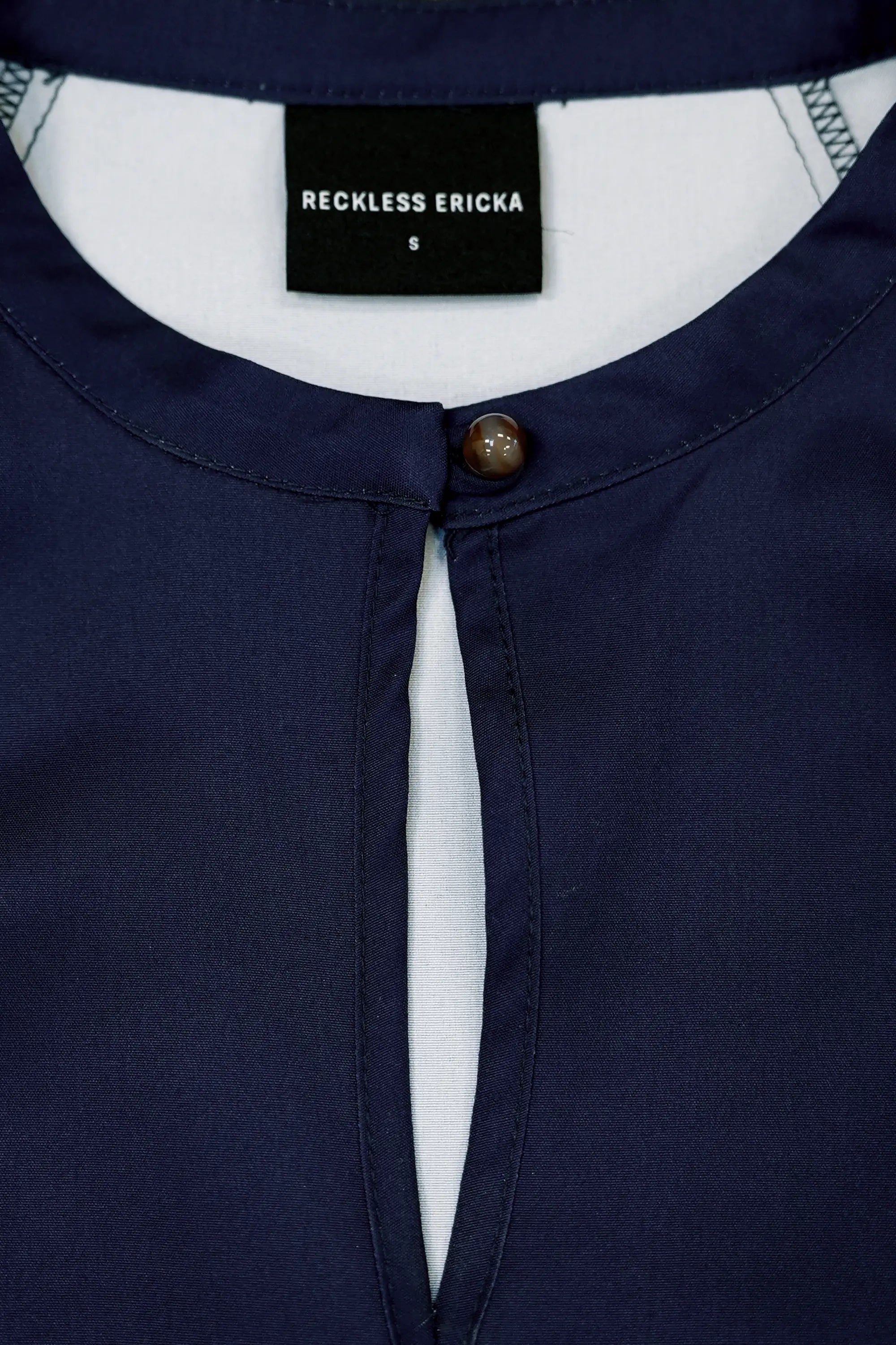 Close-up of collar loop-and-ball button on Arrayed Chrysanthemum maxi dress