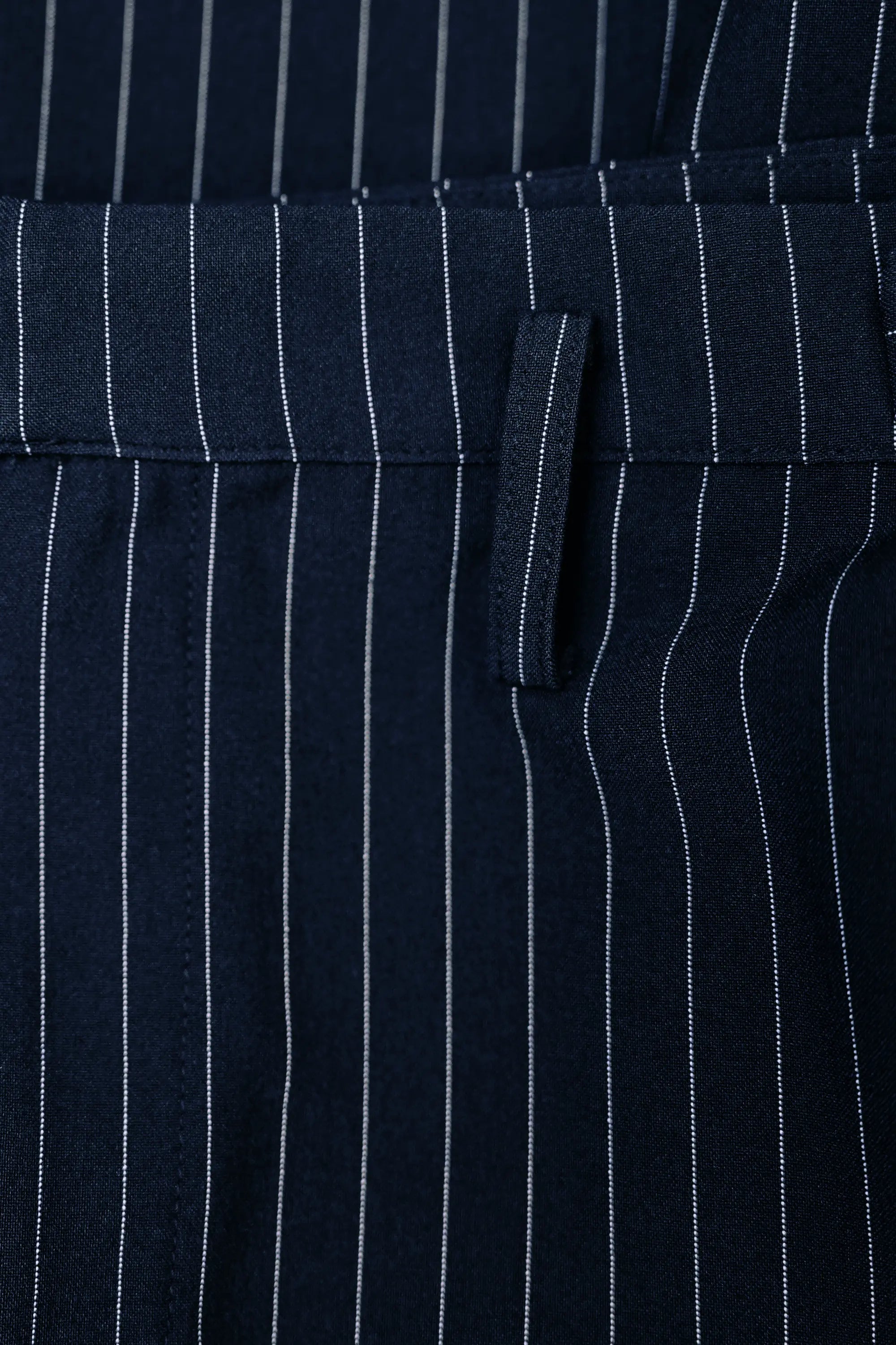 Close-up of belt loop on Arrayed navy pinstripe handkerchief skirt