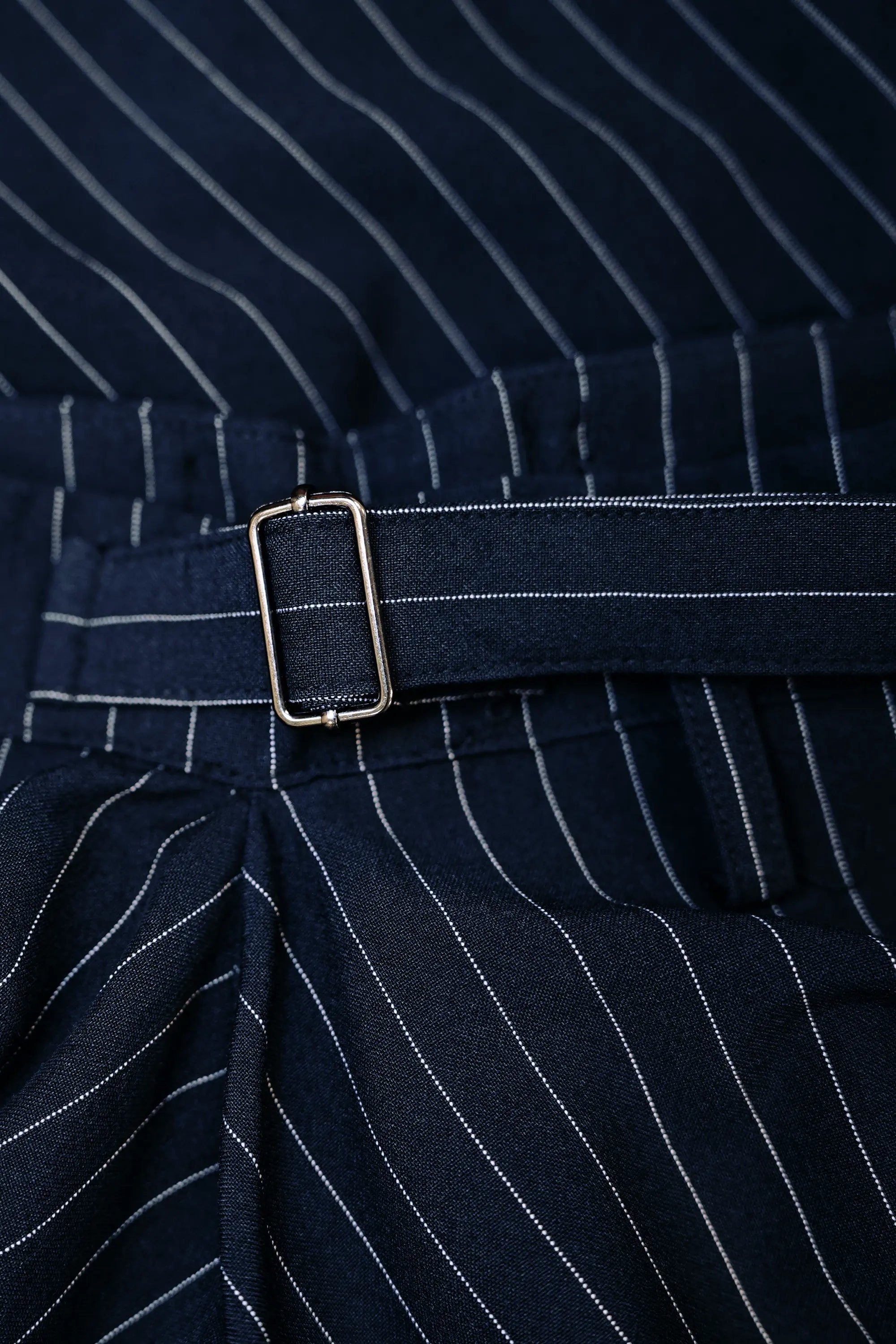 Close-up of metal side adjuster on Arrayed navy pinstripe handkerchief skirt