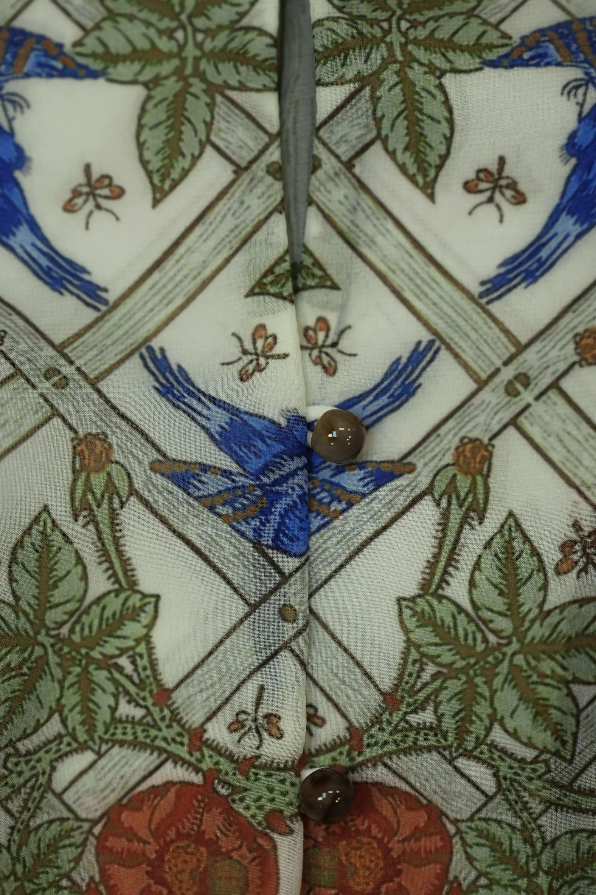 Close-up of loop-and-ball buttons on Arrayed Trellis keyhole peplum top