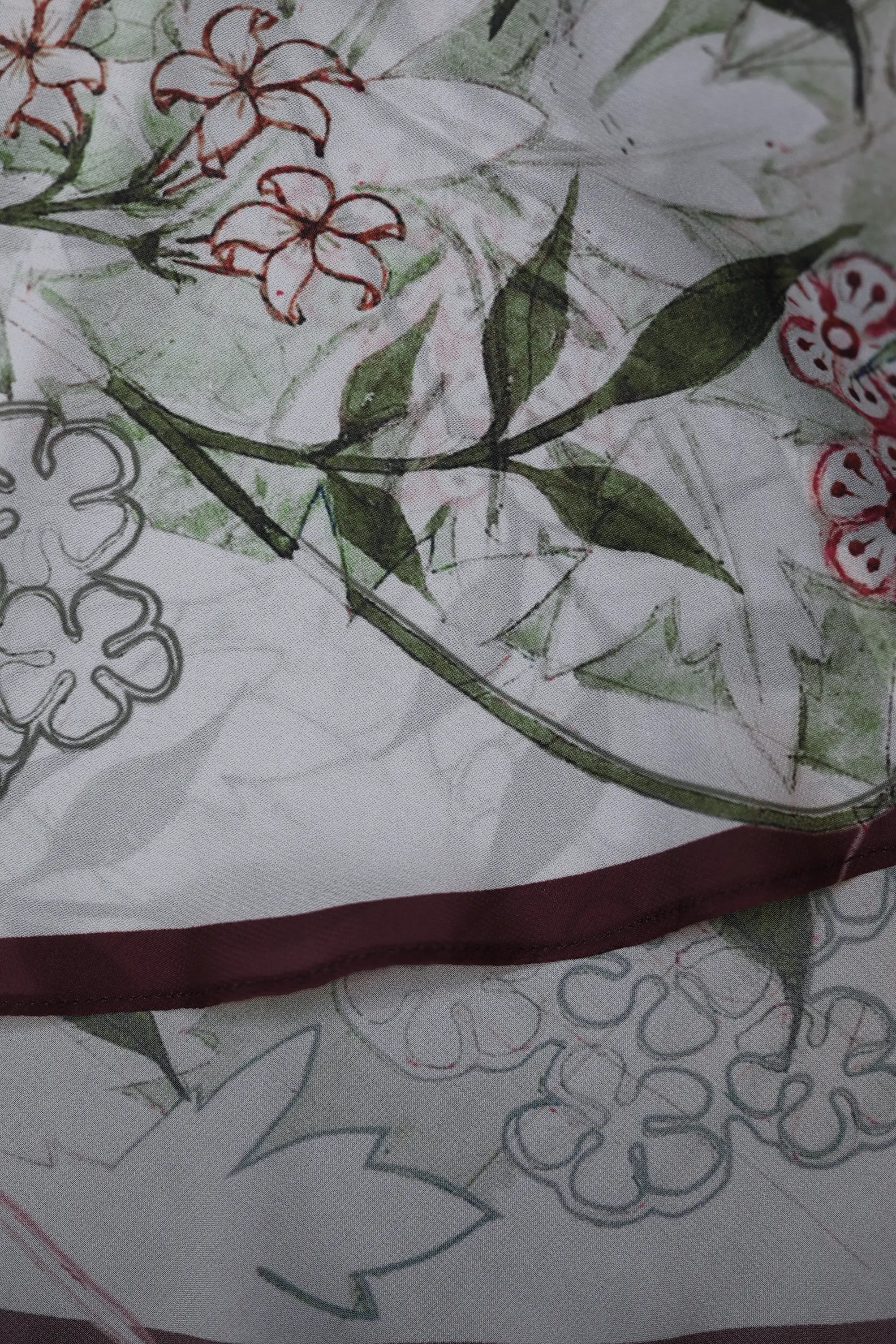 Close-up of cranberry mermaid hem border on Arrayed Jasmine maxi dress