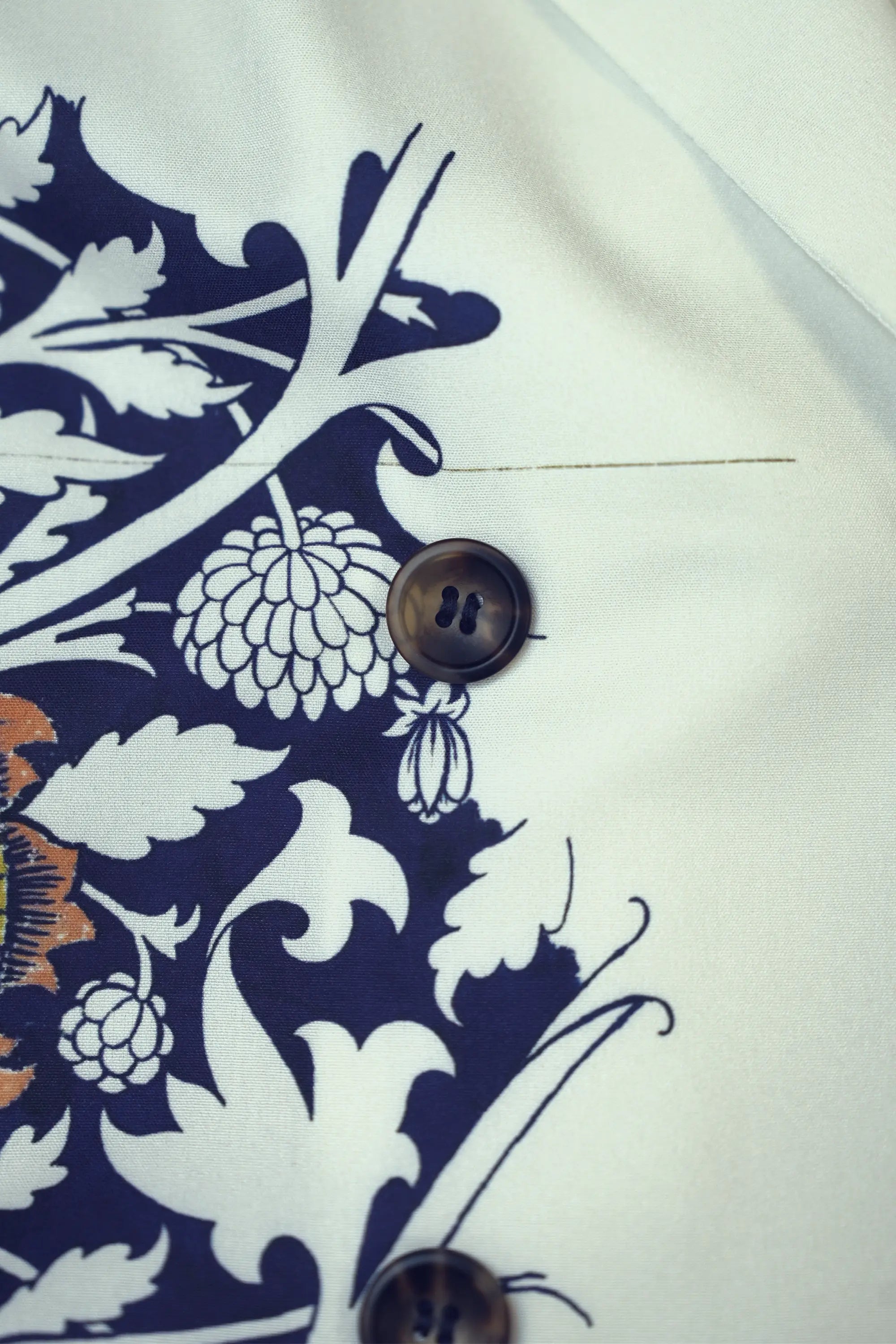 Close-up of double-breasted buttons on Arrayed Peony trench dress