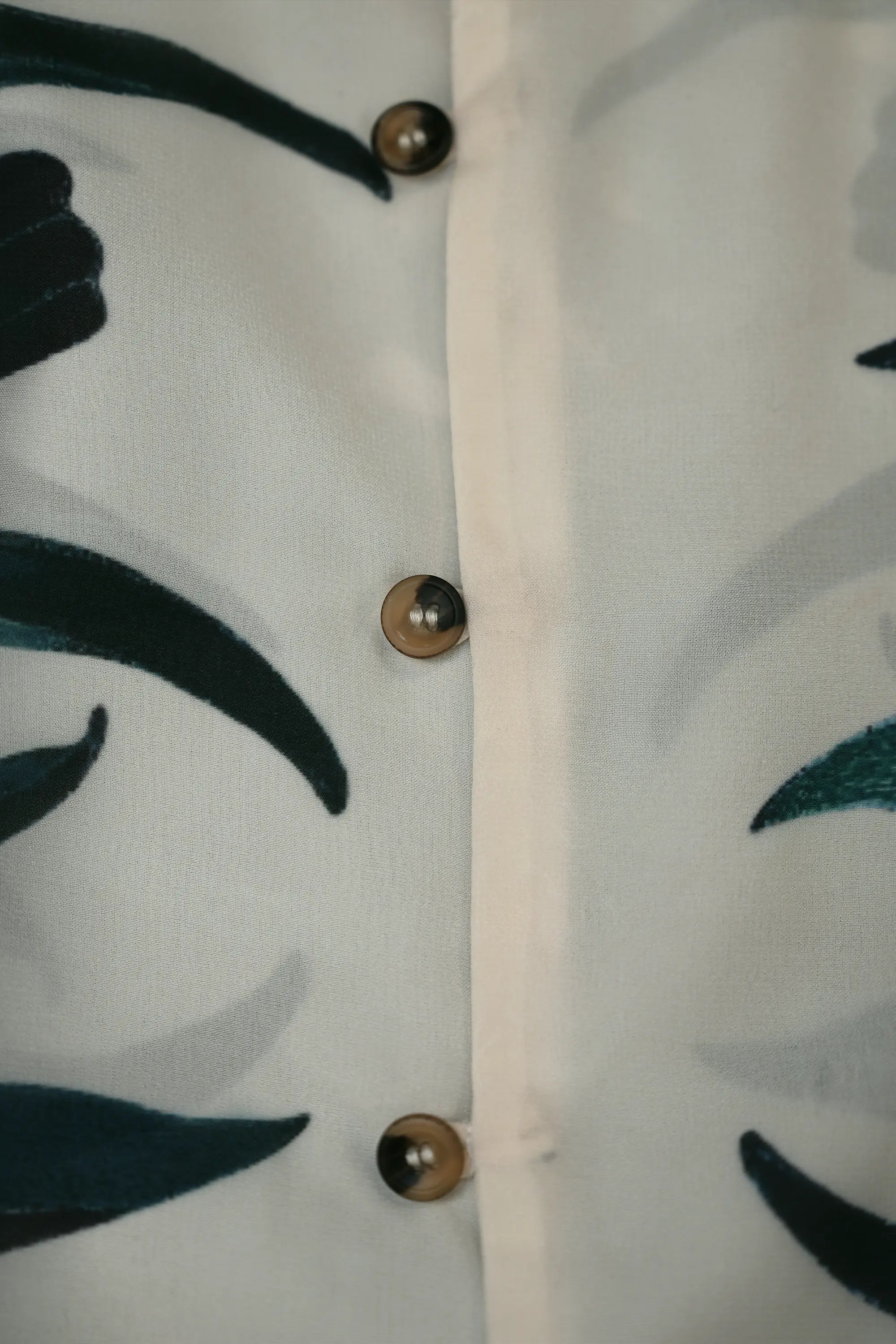 Close-up of front buttons on Arrayed Chrysanthemum Cuban shirt