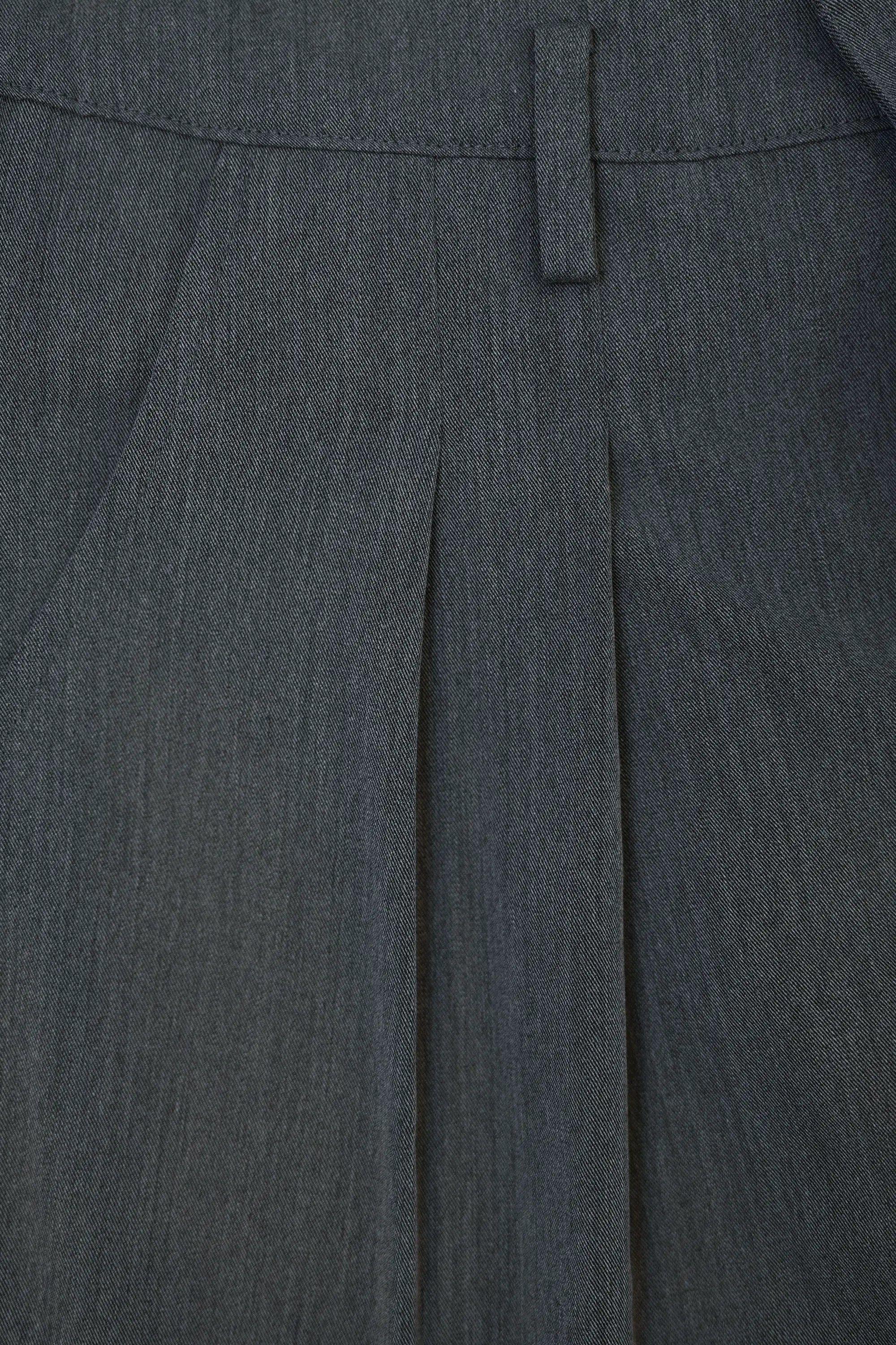Close-up of front pleats on Arrayed dark grey wrap trousers