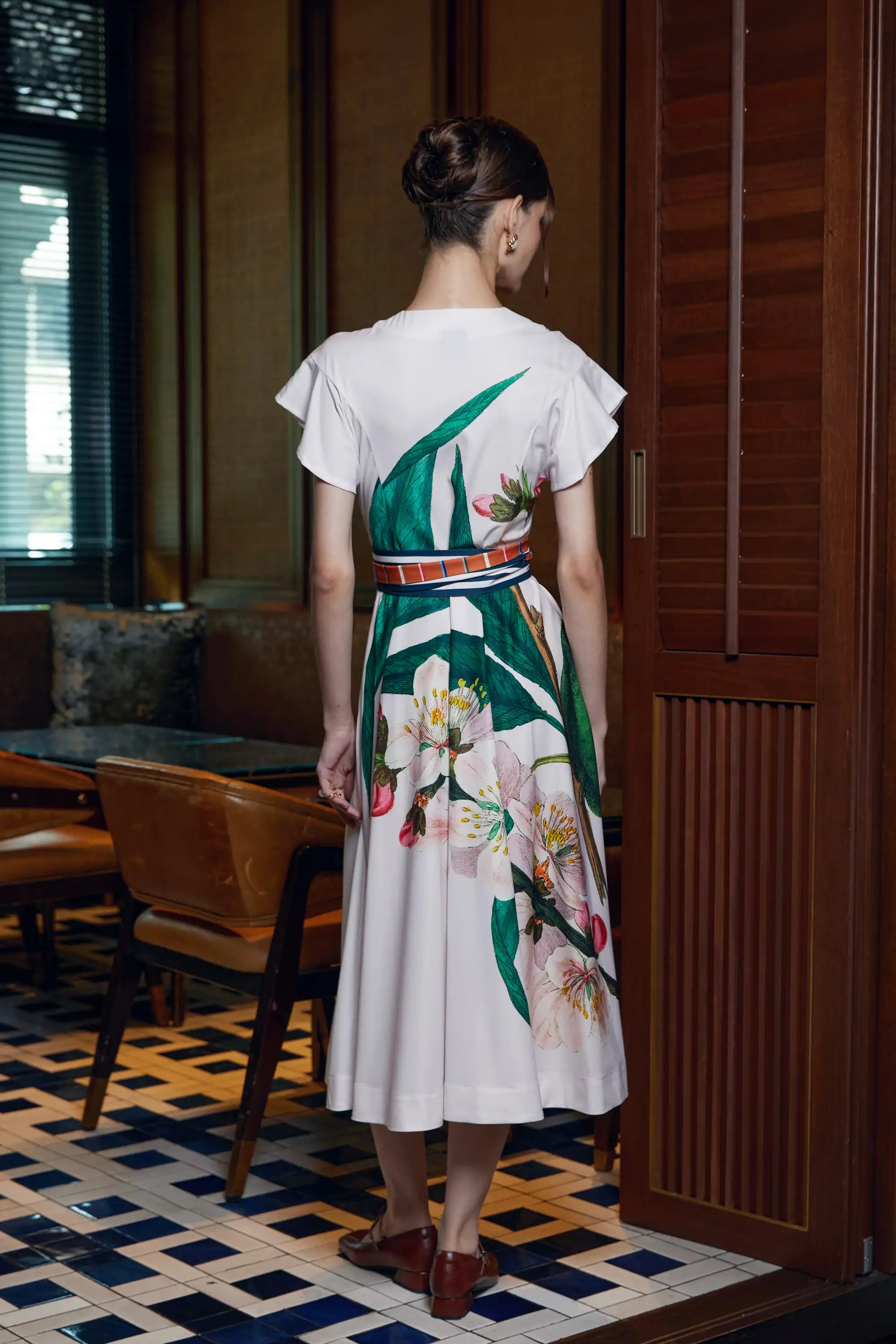 Woman wearing Arrayed ivory Almond print midi dress, back view