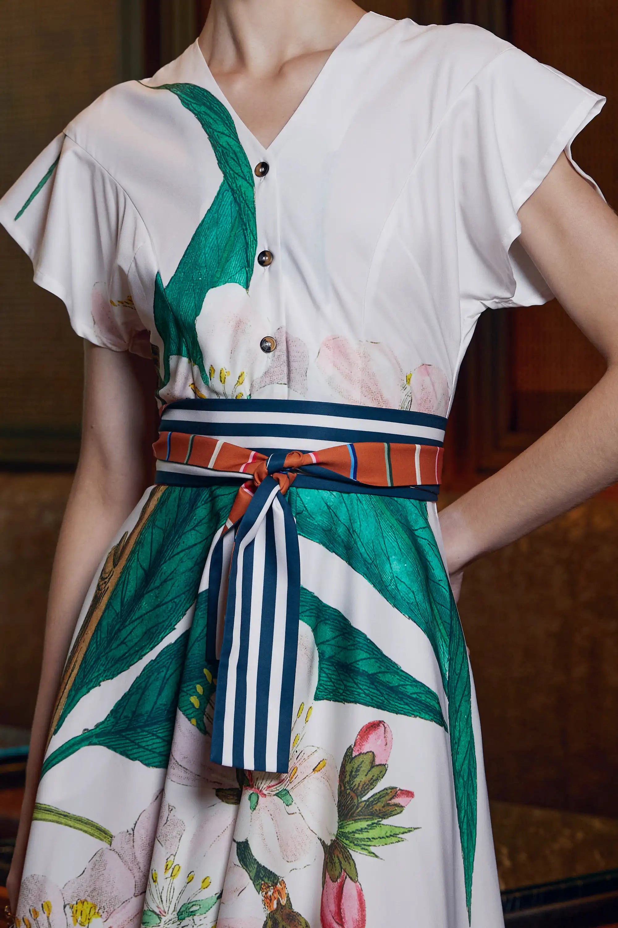 Close-up of Arrayed ivory Almond print dress with buttons and striped sash