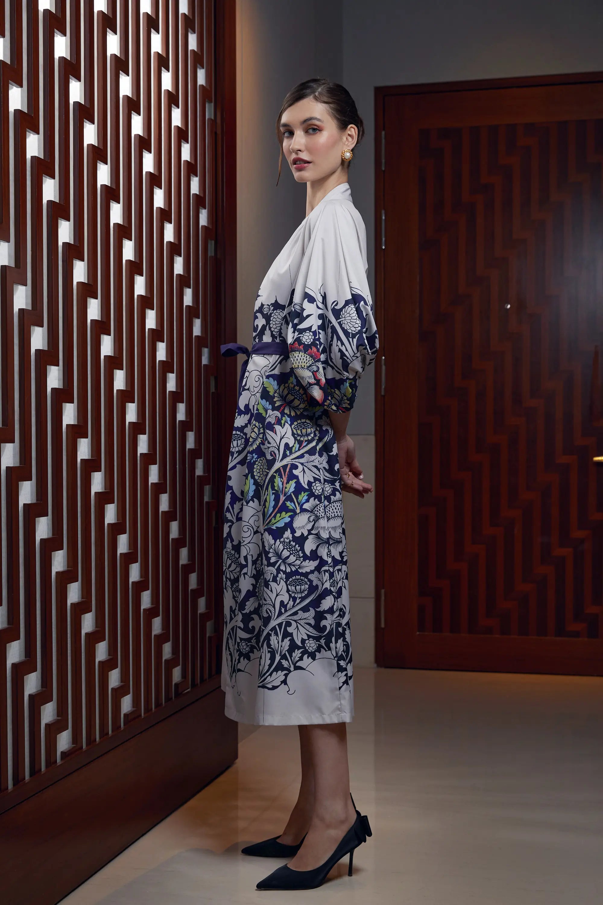Woman wearing Arrayed Peony print calla sleeve wrap maxi dress, side view
