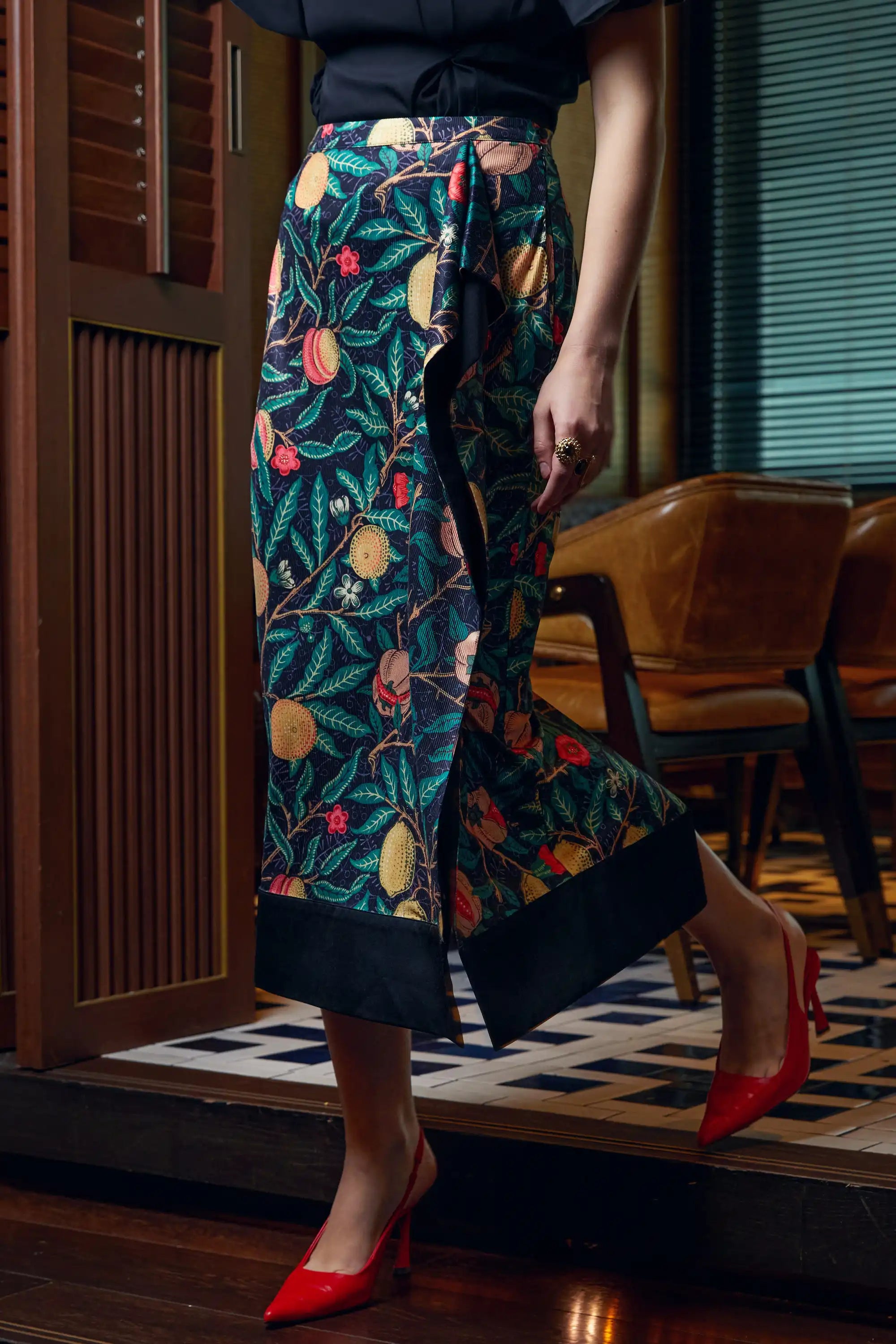 Side view of Arrayed black Pomegranate print ribbed midi skirt
