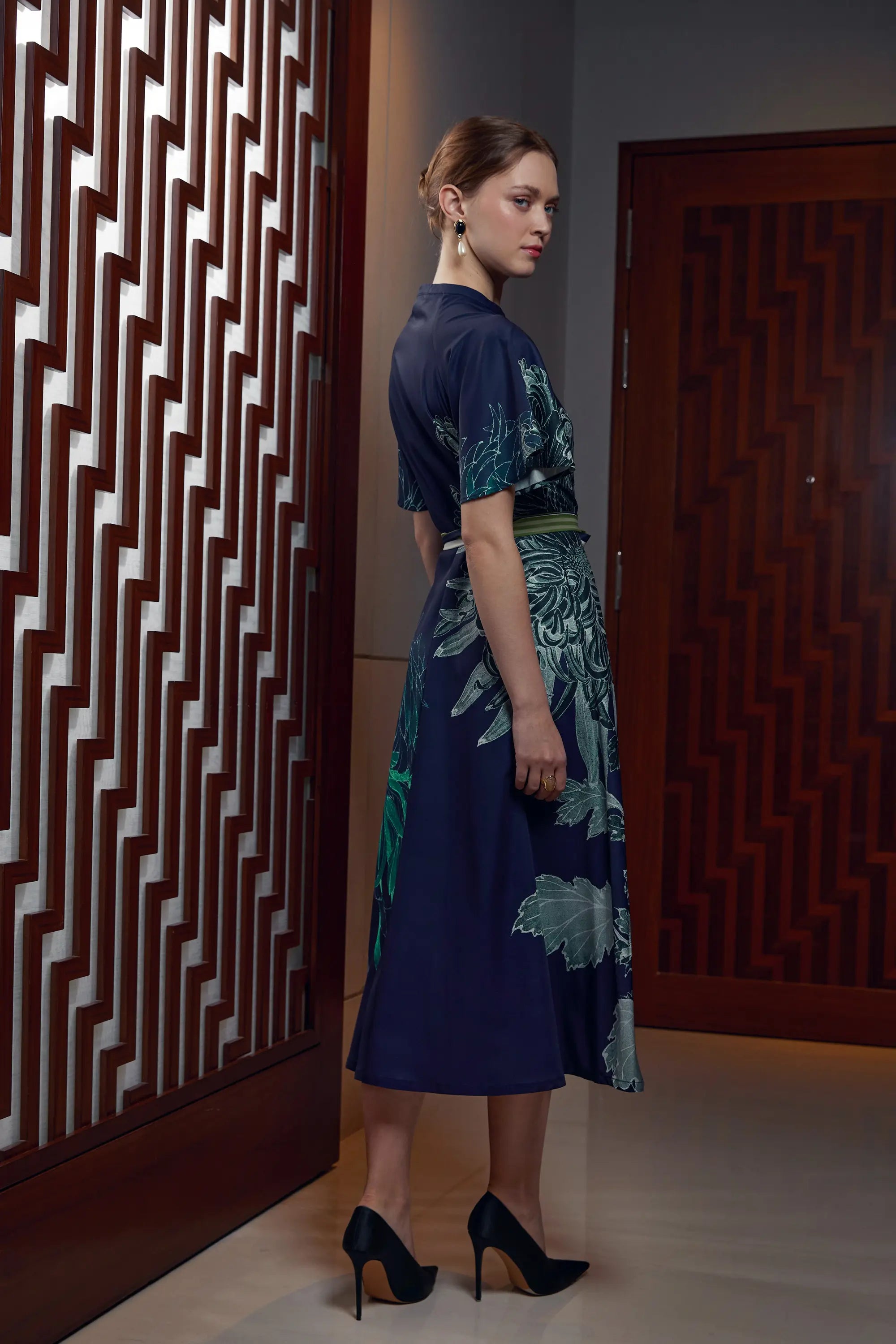 Woman wearing Arrayed Chrysanthemum keyhole maxi dress with flutter sleeves, side view