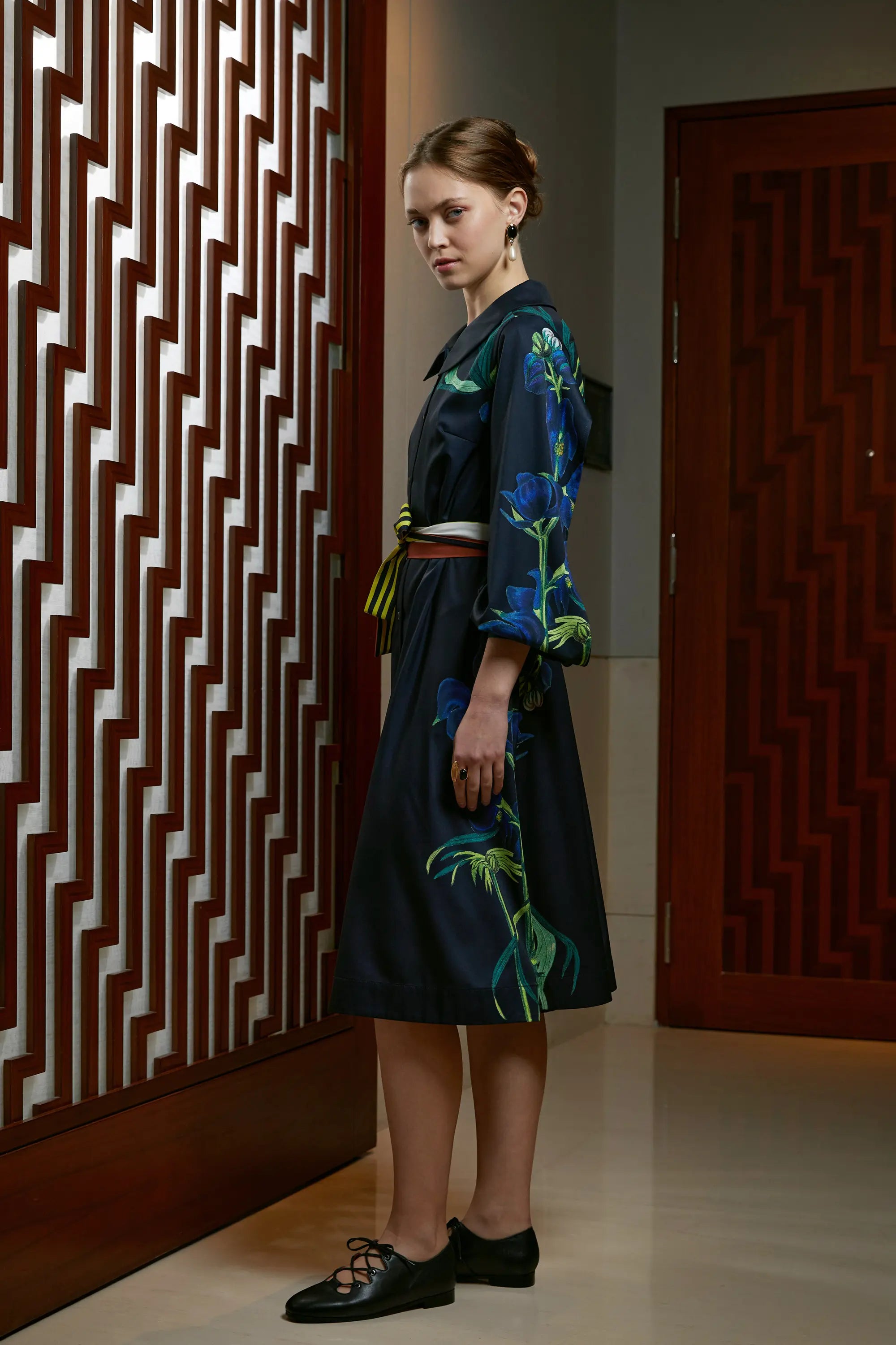 Woman wearing Arrayed Monk's Hood print folded sleeve shirt dress, side view