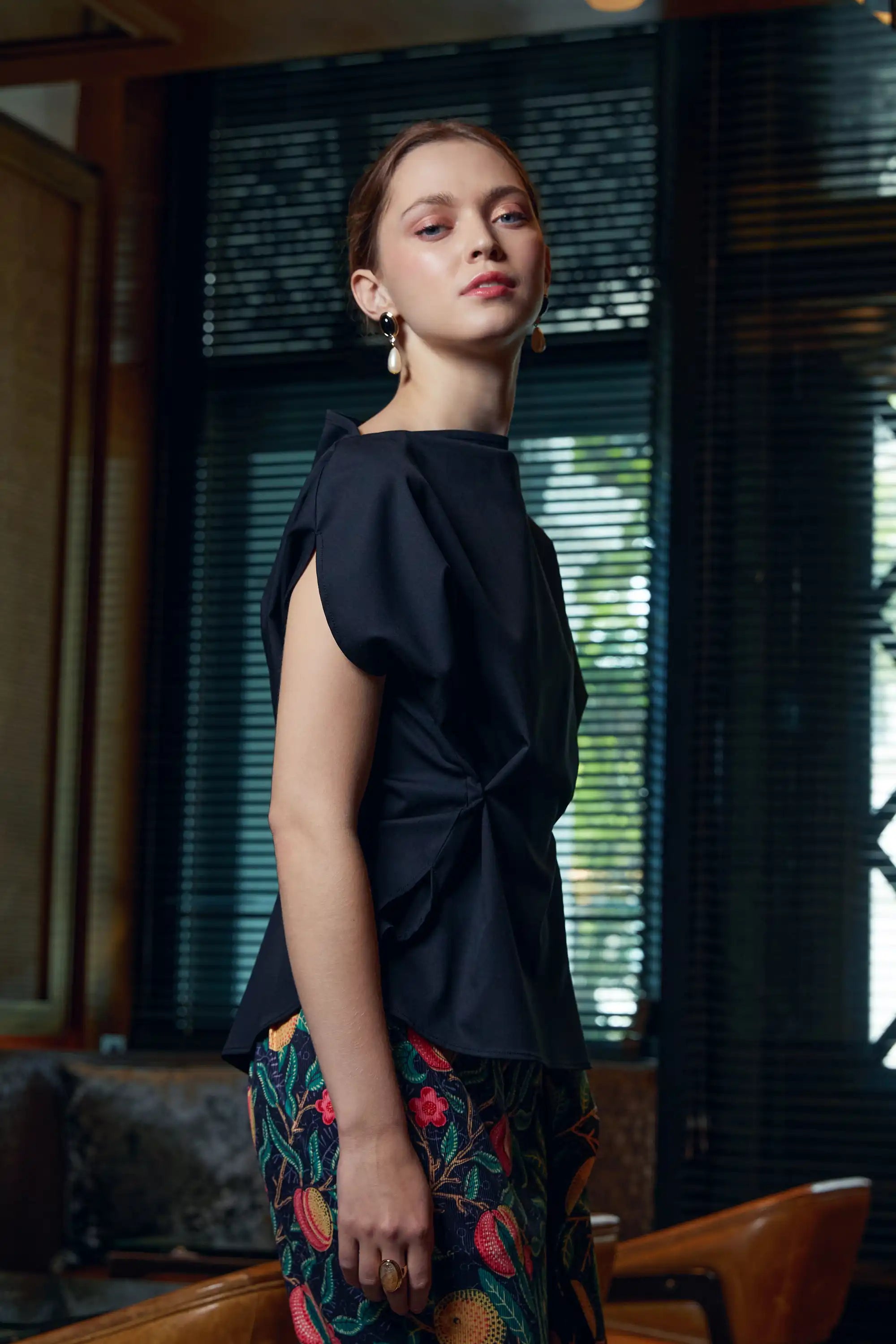 Woman wearing Arrayed black adjustable top with side fold detail