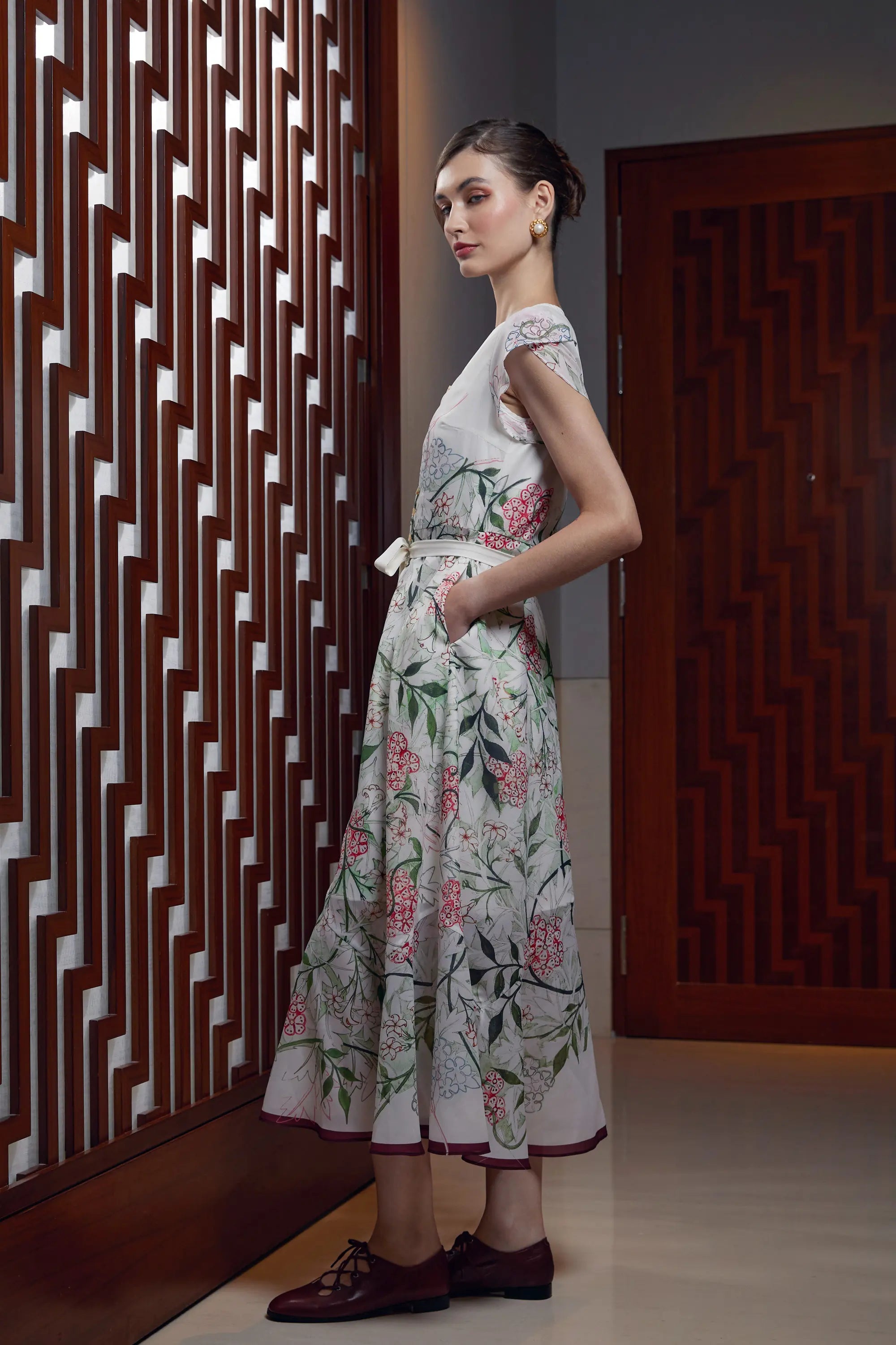 Woman wearing Arrayed Jasmine print petal sleeve mermaid dress, side view