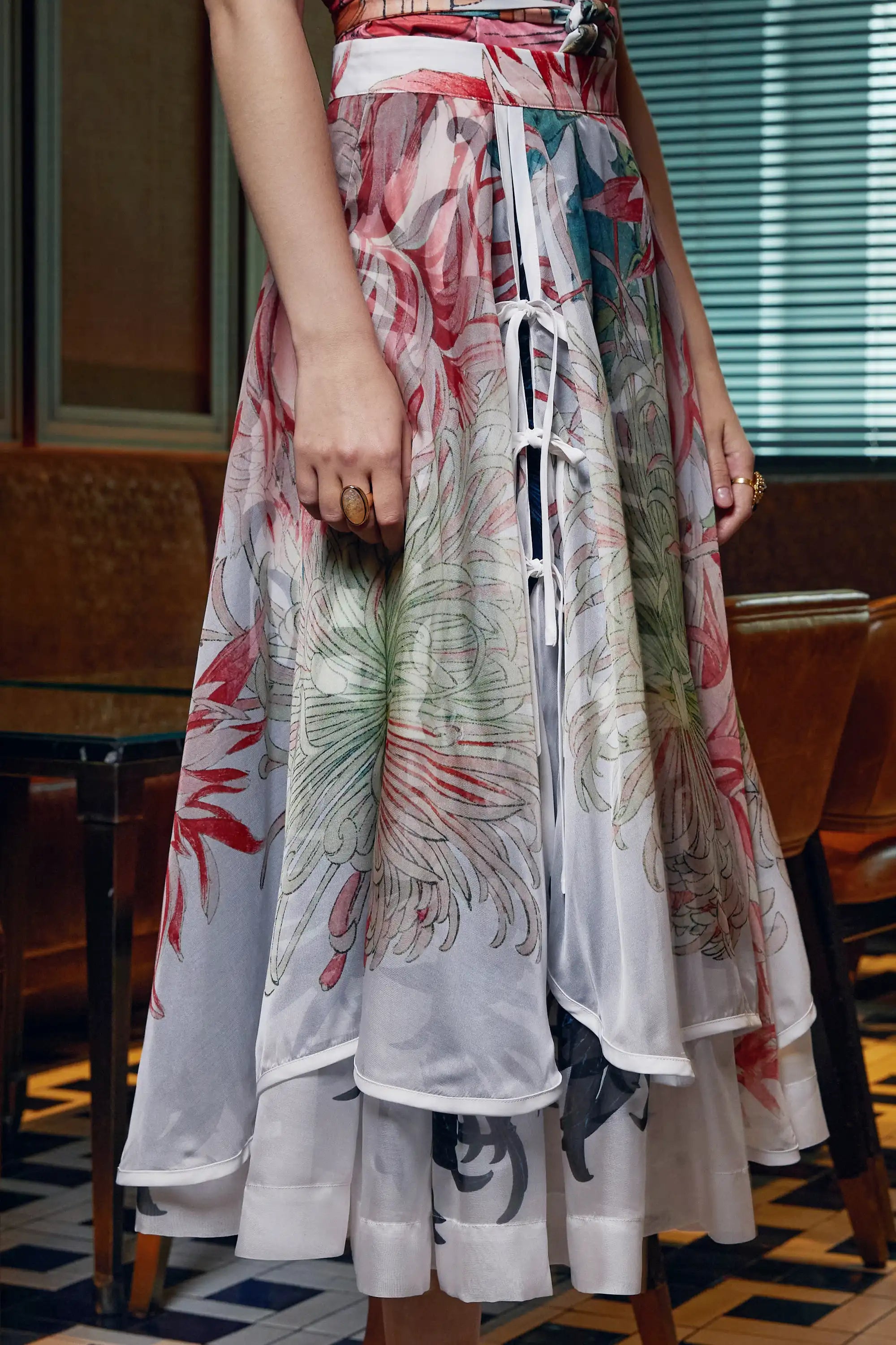 Close-up of white piping detail on Arrayed Chrysanthemum print organza skirt