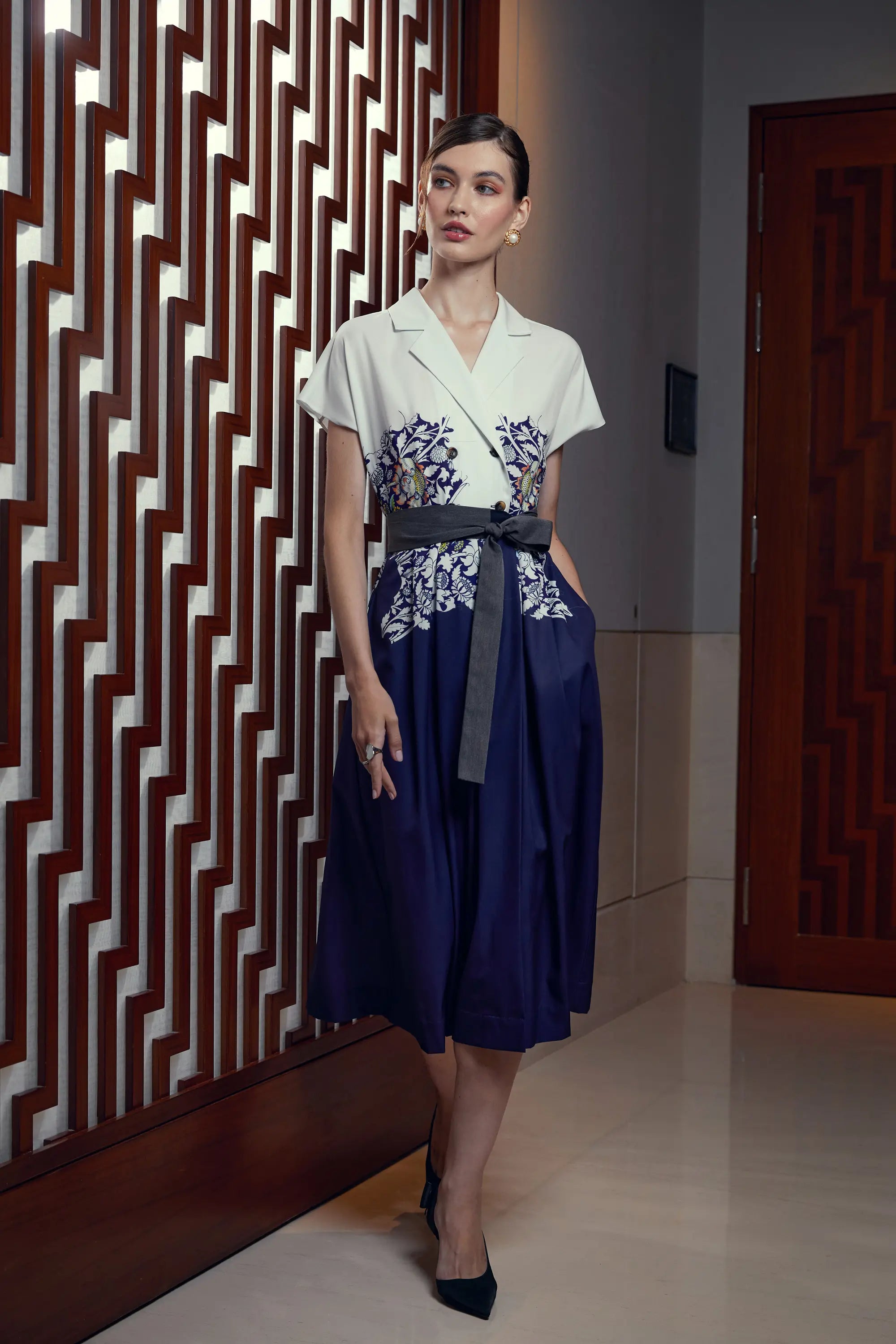 Woman wearing Reckless Ericka Arrayed Peony print trench midi dress in ivory, front view