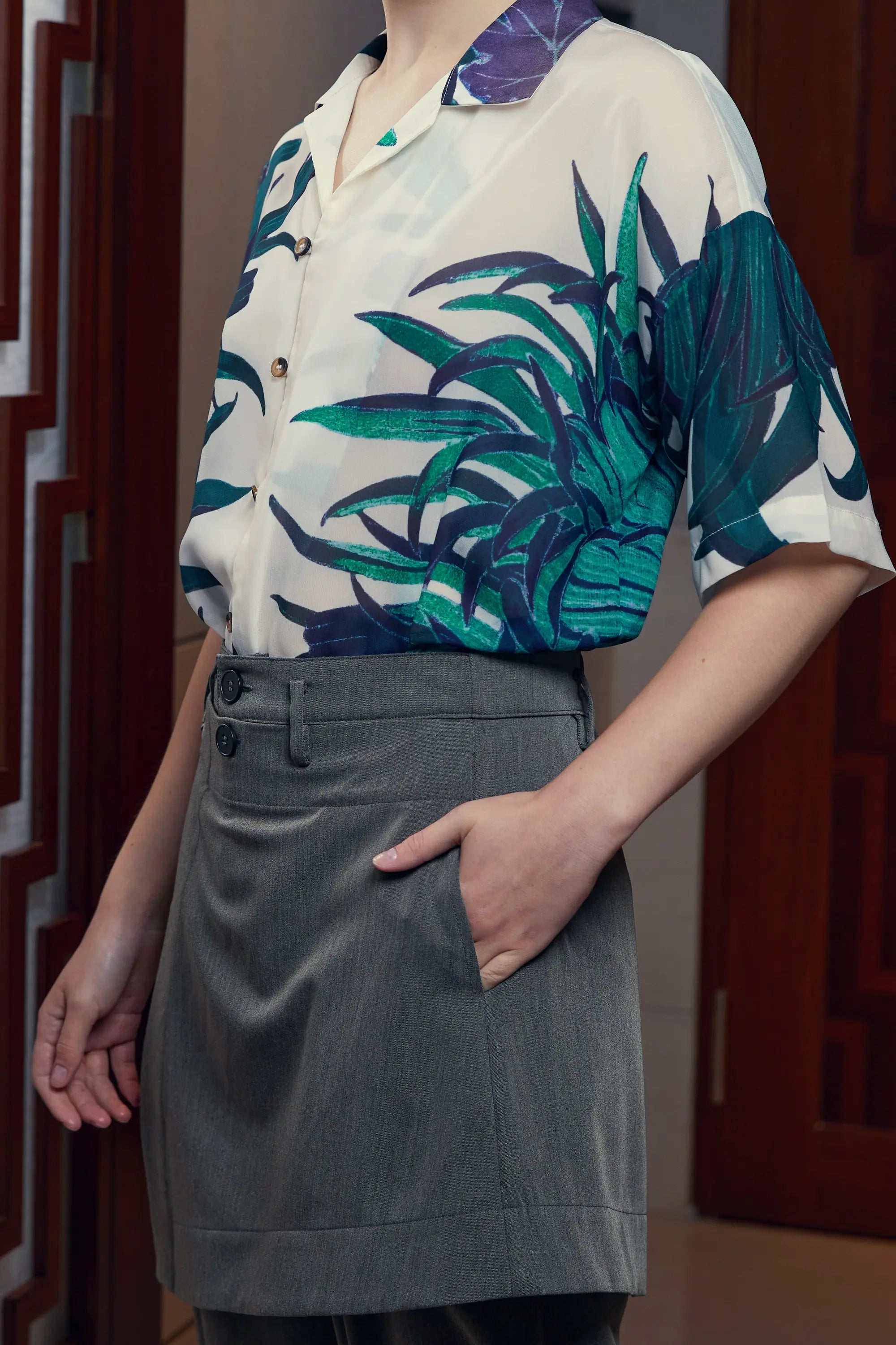 Arrayed Chrysanthemum Cuban shirt with dark grey wrap trousers, styling detail