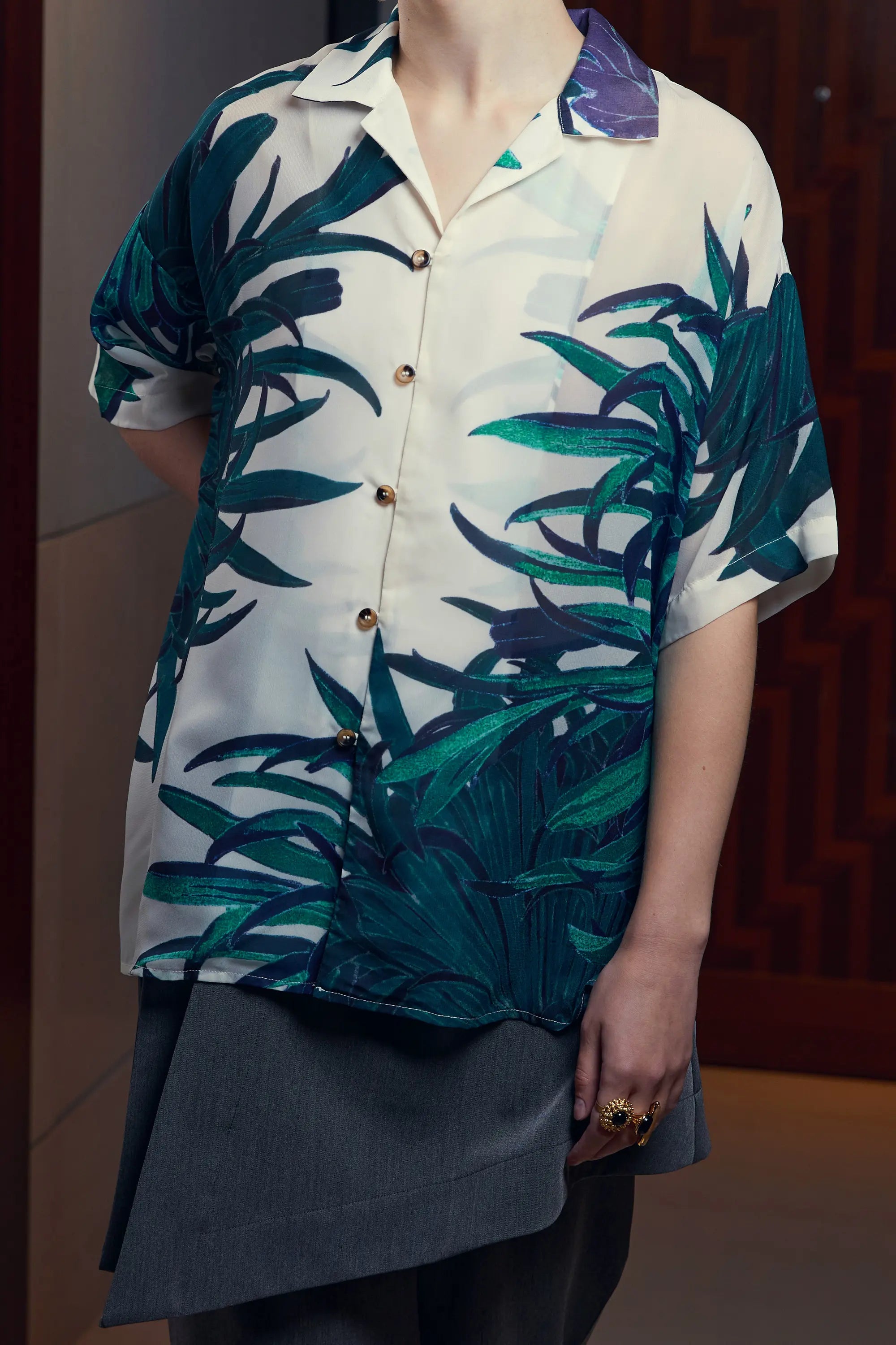 Arrayed Chrysanthemum Cuban shirt styled with dark grey wrap trousers, detail