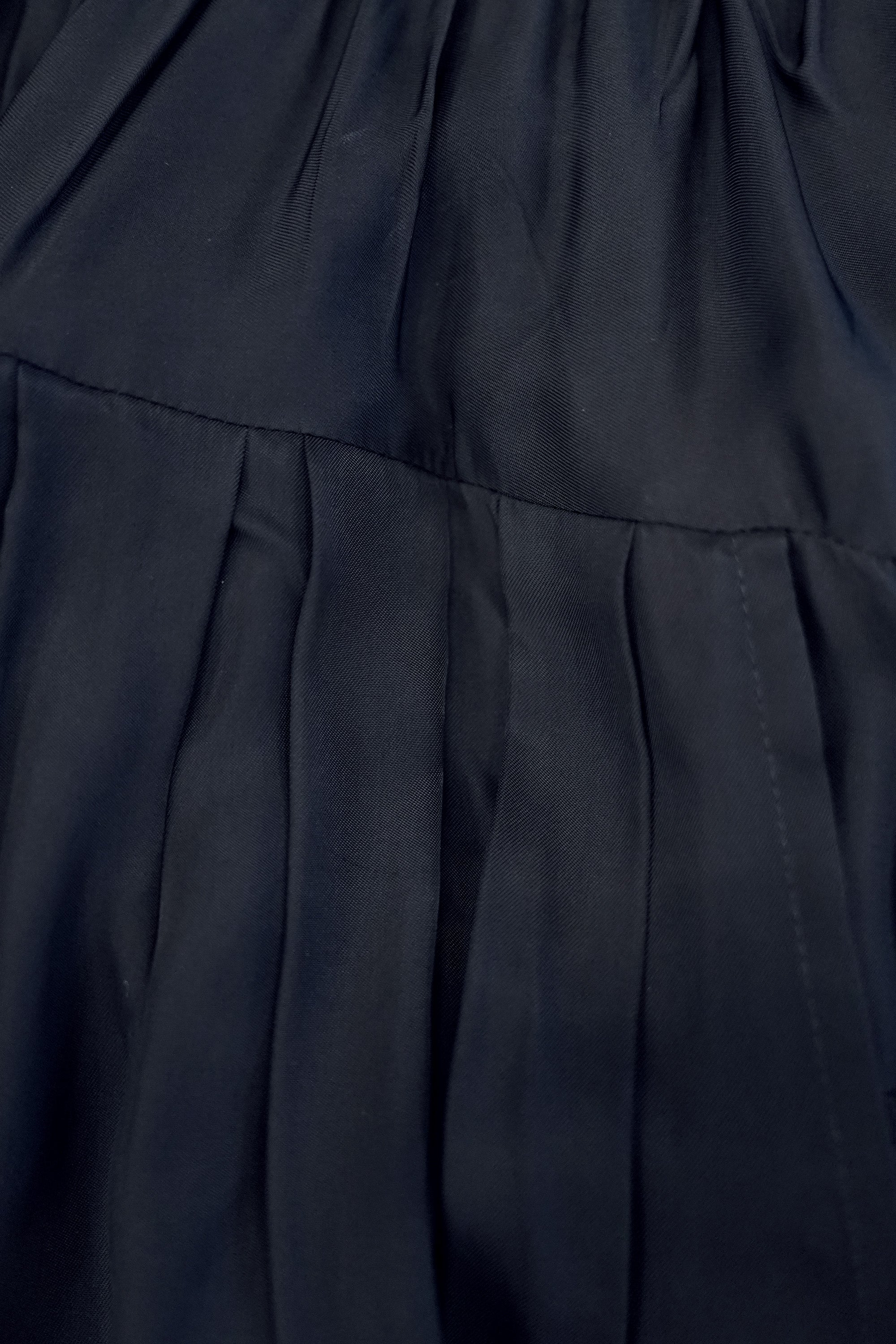 Close-up of billowing skirt showcasing box pleats and panelled construction for volume and movement