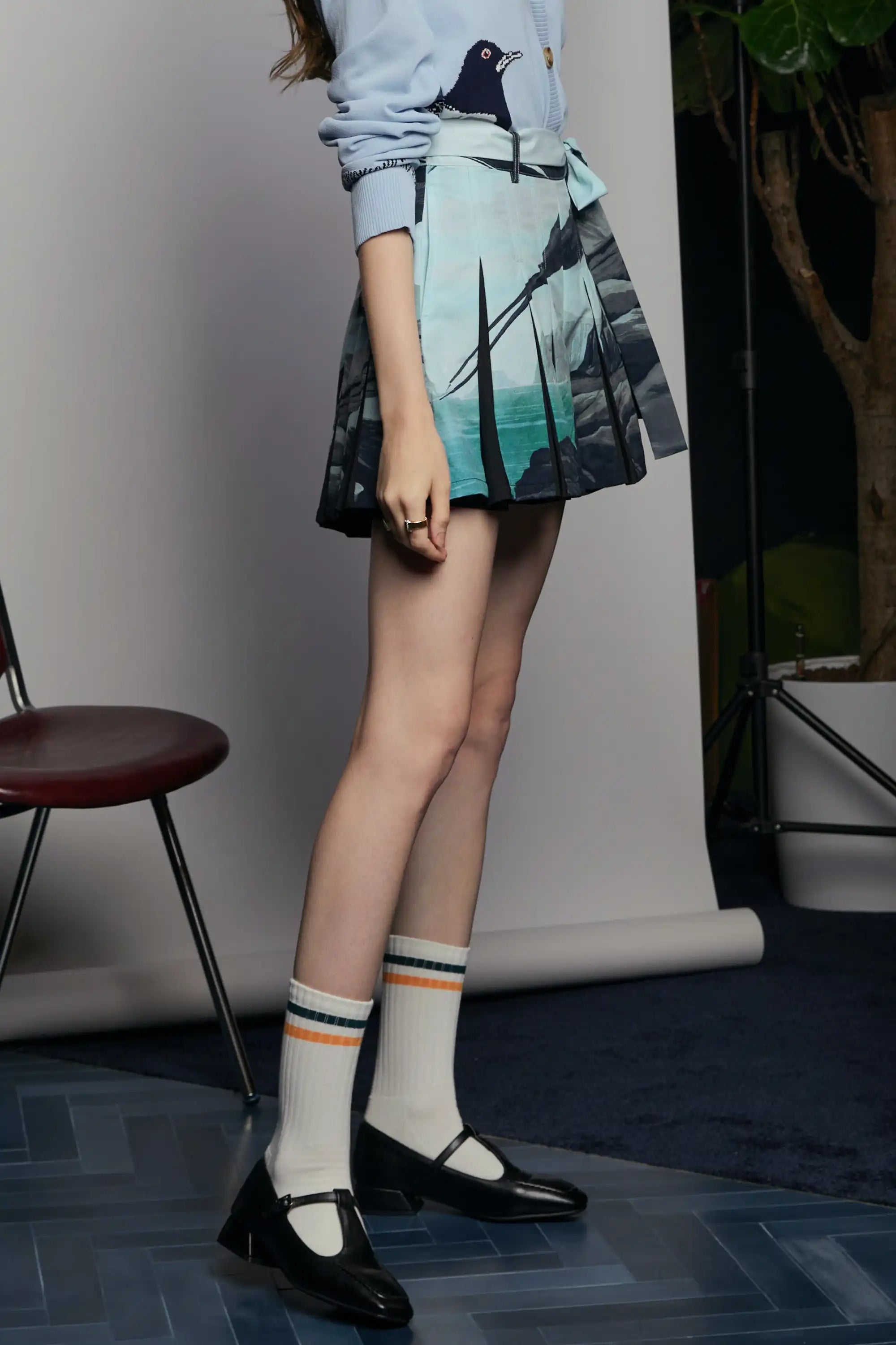 Side view of the Haven Godet Box Pleat Shorts in Arctic Skua print, highlighting the sweeping horizon artwork across the pleats, the sculptural flare from the godet inserts, and the clean high-waisted cut that flatters the form.