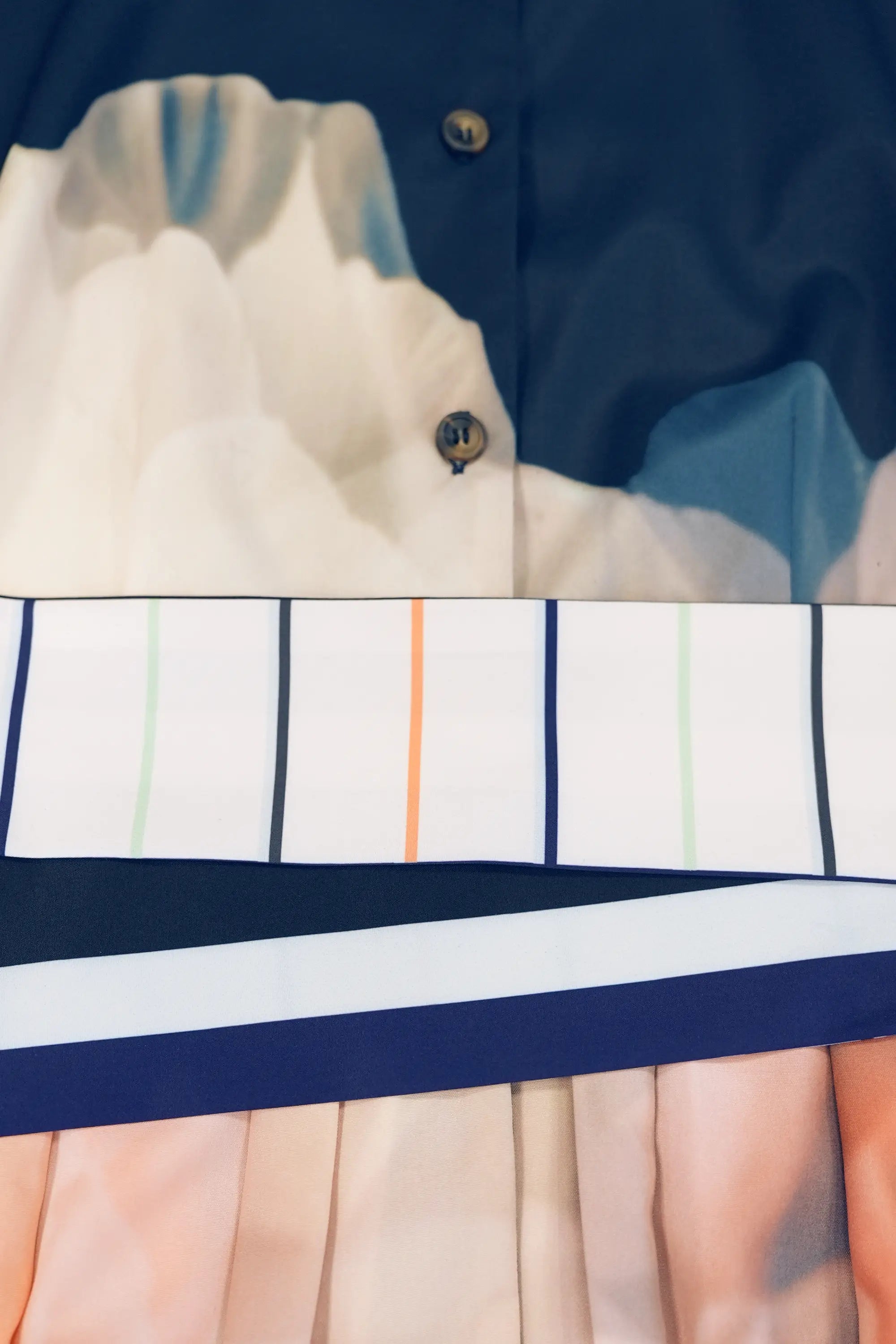 ABIDE placement print midi dress striped sash belt and pleat detail in navy (close-up)