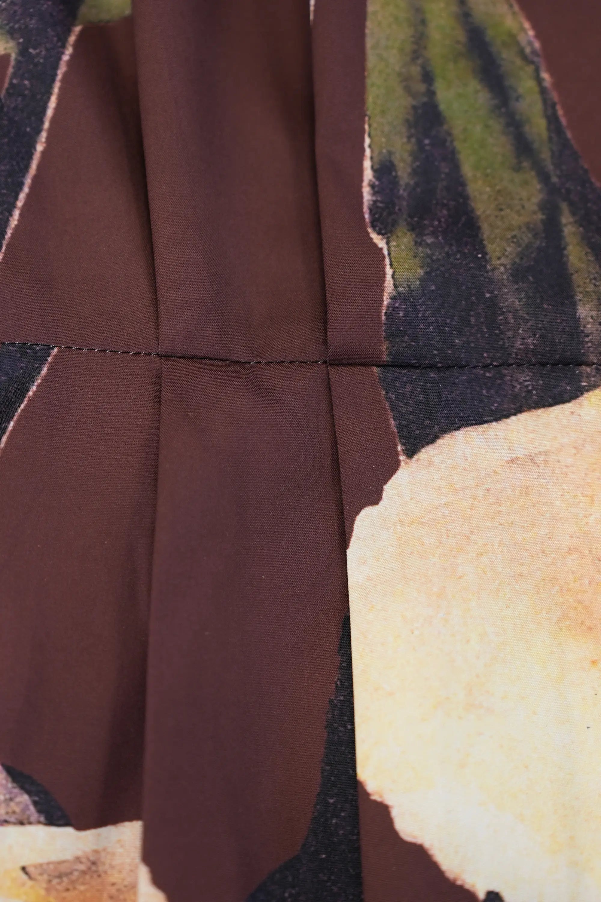 ABIDE printed dress structured pleat and waist seam detail (close-up)