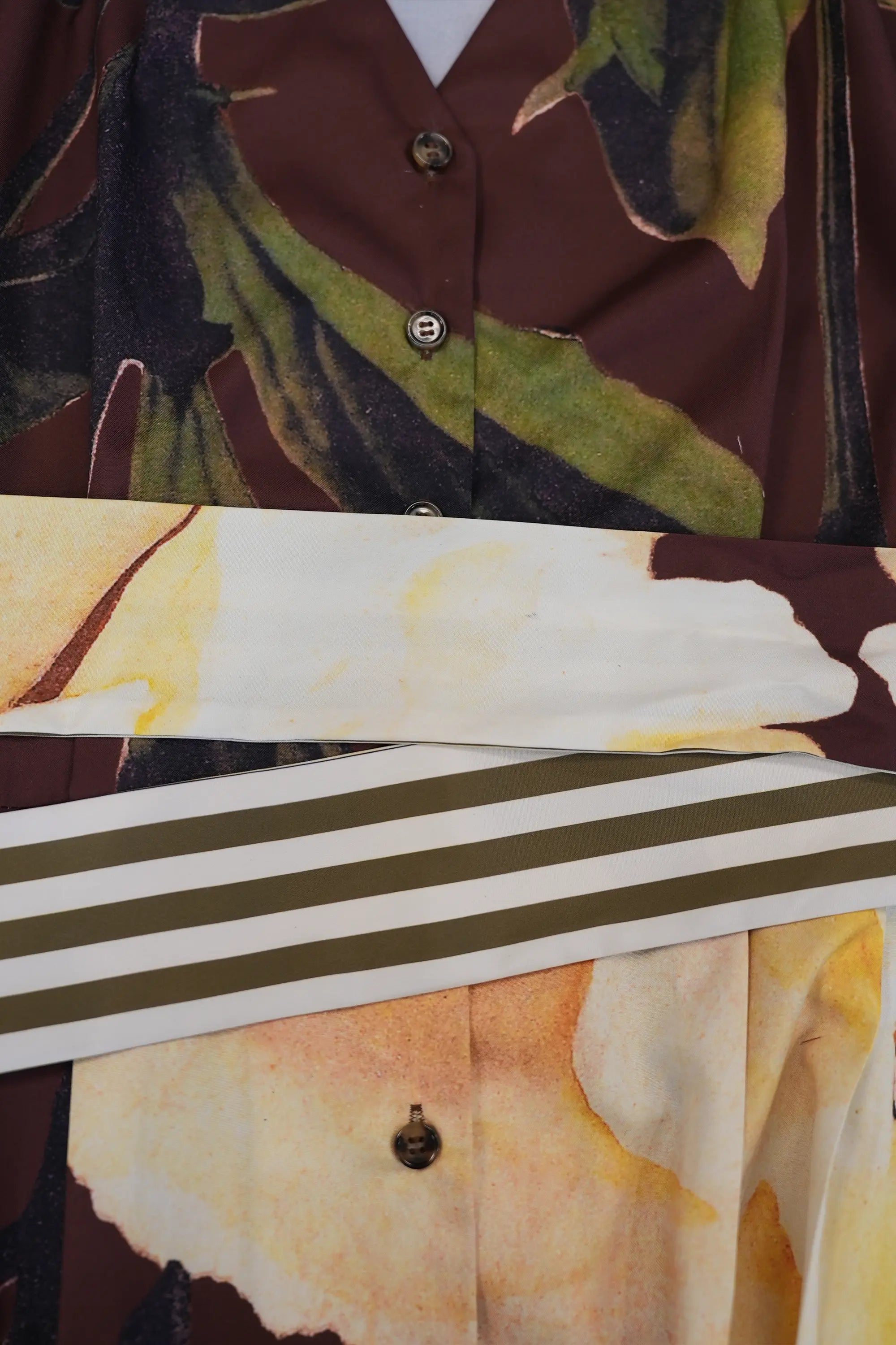 ABIDE floral midi dress contrast sash belt layering and print placement detail (close-up)