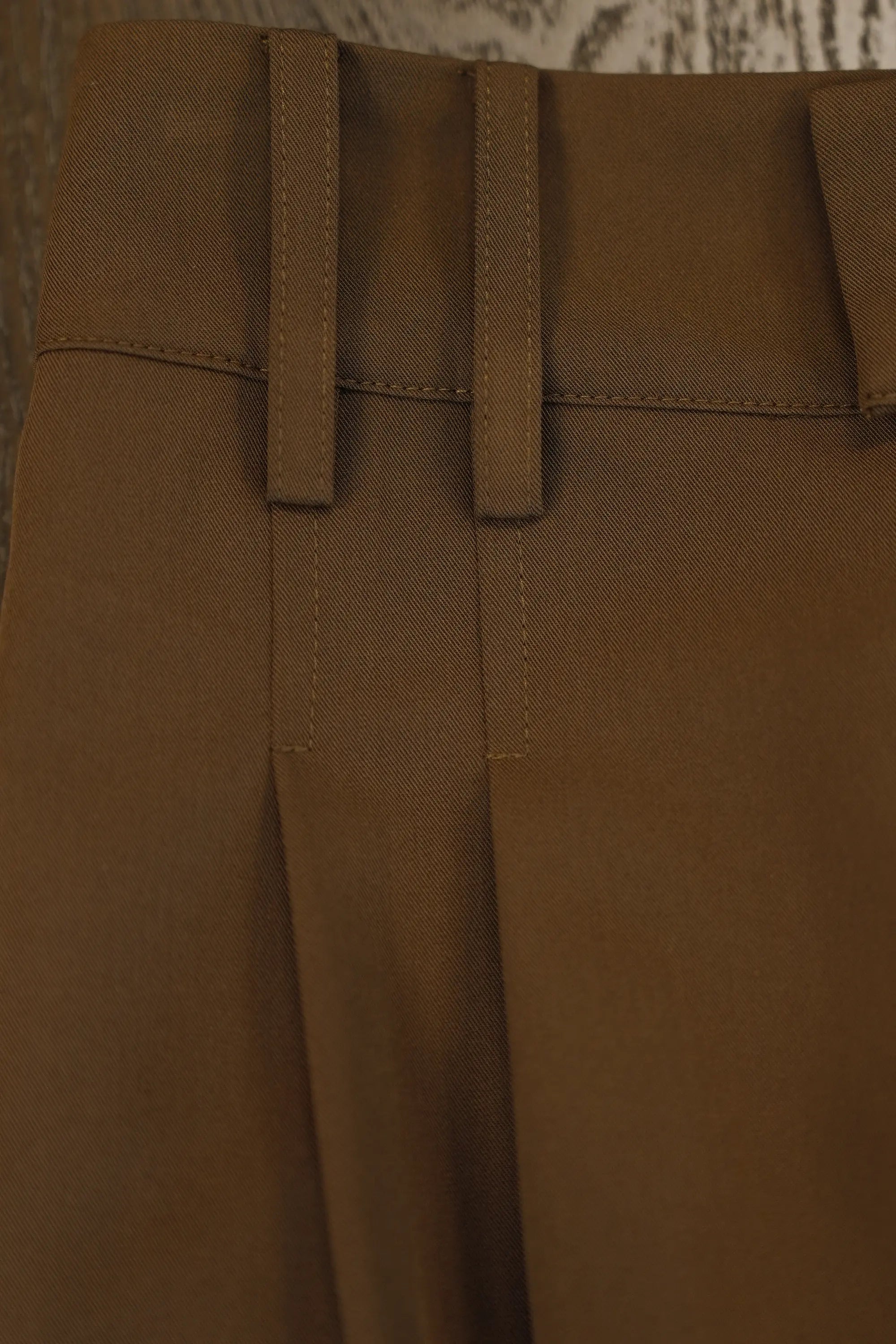 Close-up of ABIDE brown pants with belt loops