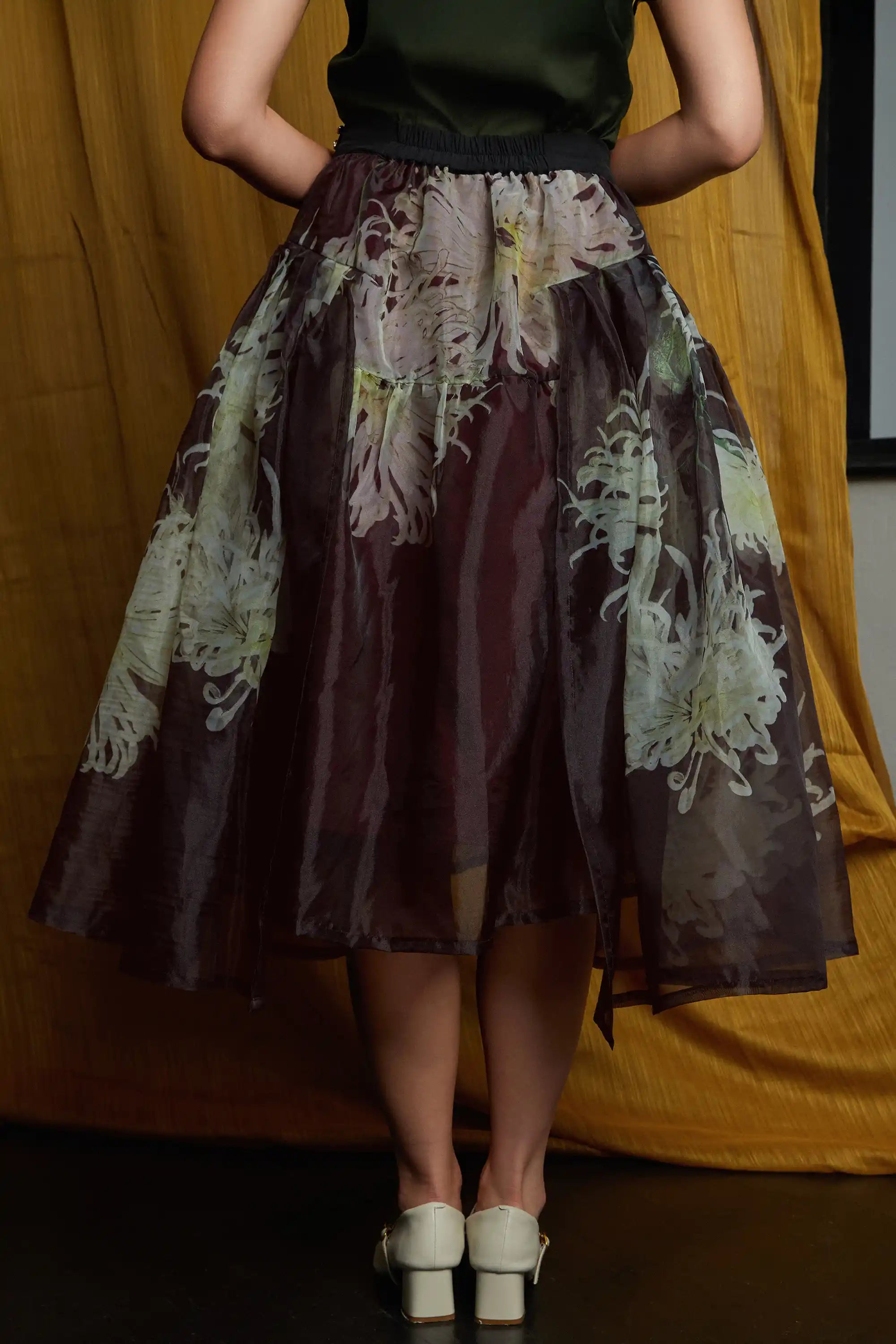 Sheer floral overlay skirt with clean waistband finish and gentle volume, showcasing layered construction and a refined, flowing silhouette