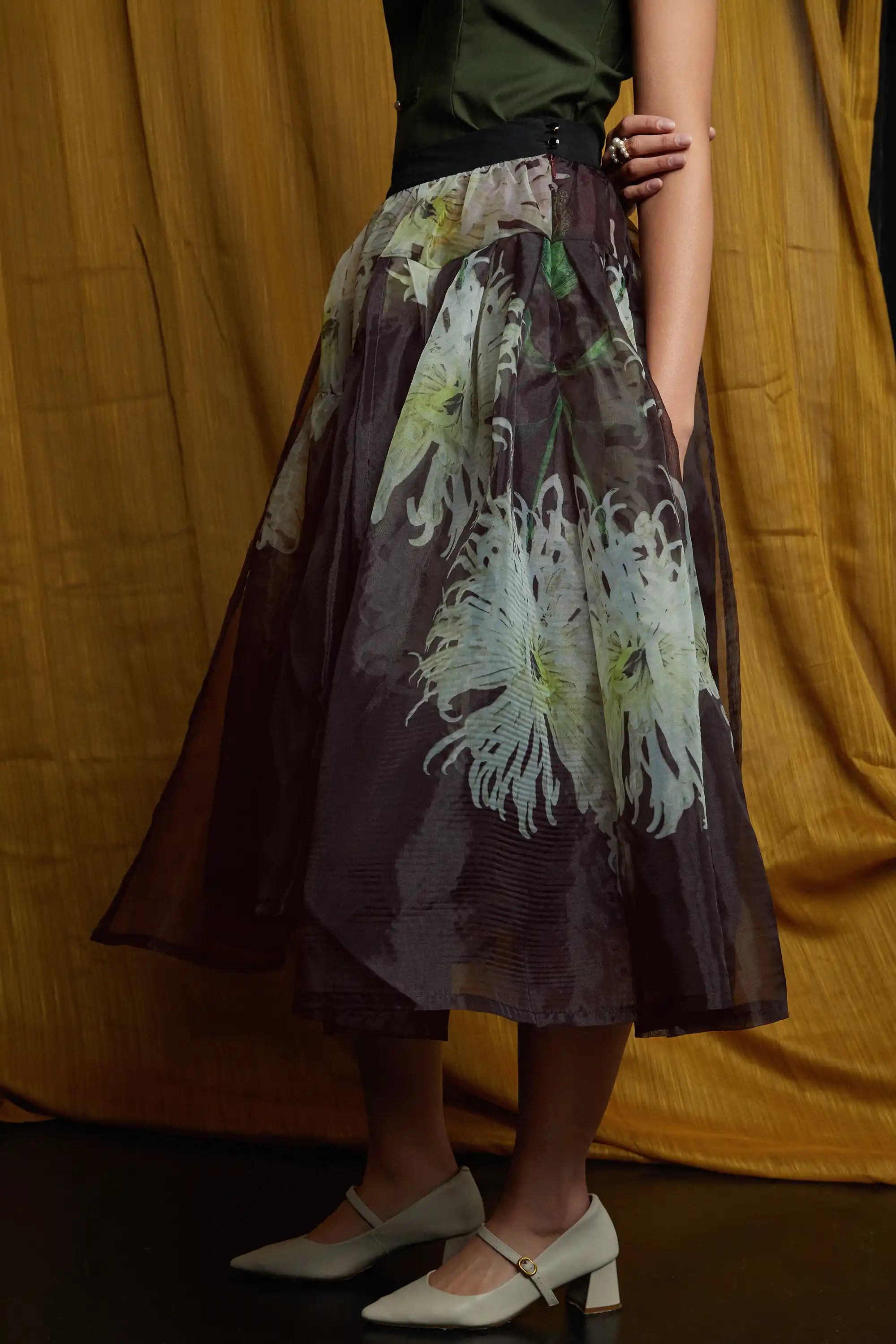 Sheer floral skirt with airy overlay and fluid drape, highlighting light-catching texture and a softly flared silhouette