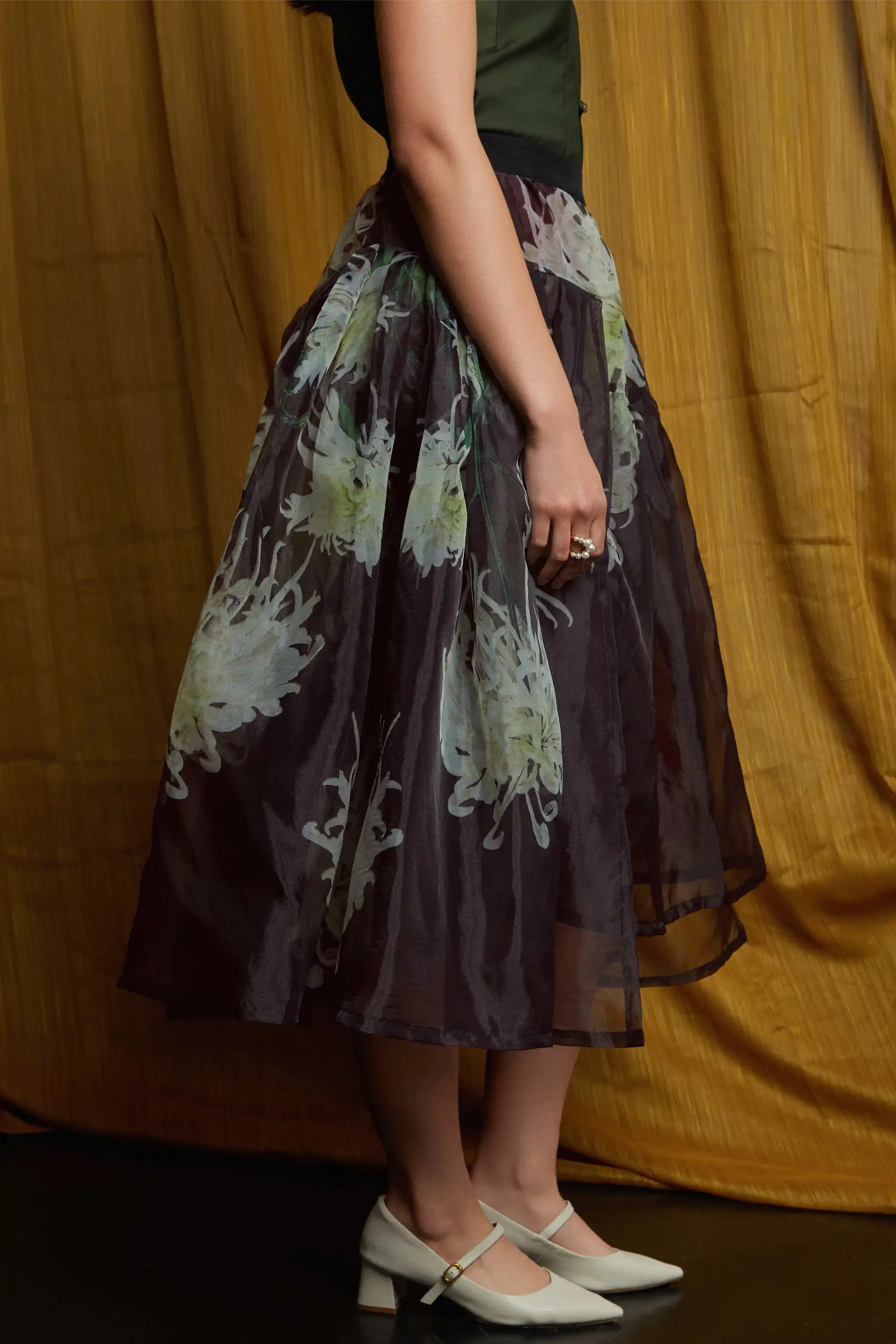 Sheer floral skirt with airy overlay and fluid drape, highlighting light-catching texture and a softly flared silhouette