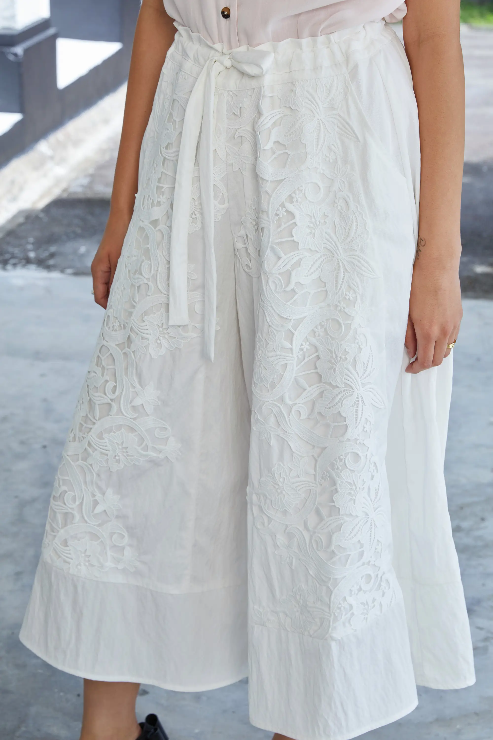 White lace wide-leg culottes with floral embroidery, high-waisted tie belt and soft gathered waist