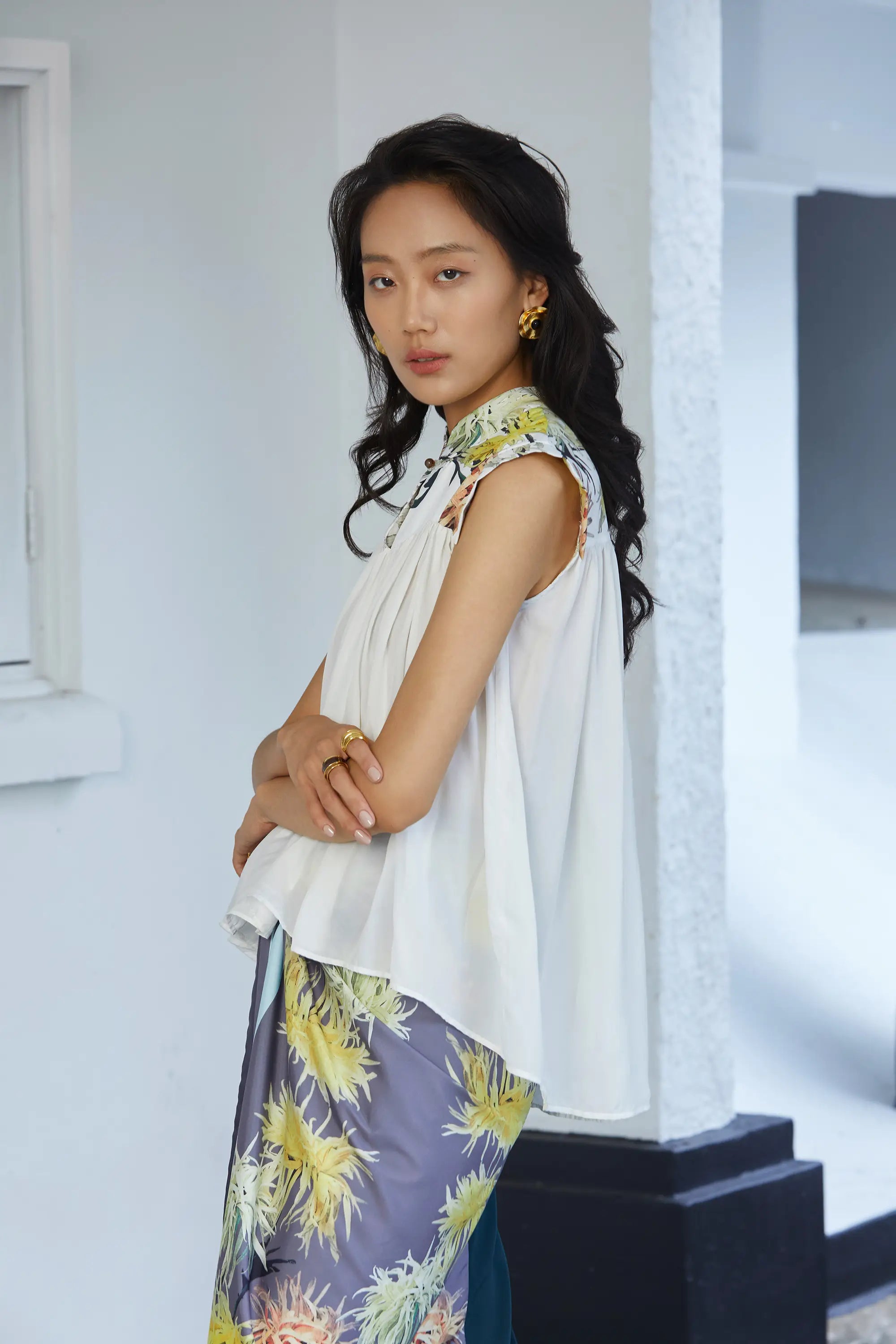 Lightweight blouse with gentle volume and a relaxed fit, showcasing the layered drape and slight high-low hem effect, with the printed collar and cap sleeves framing the shoulders.