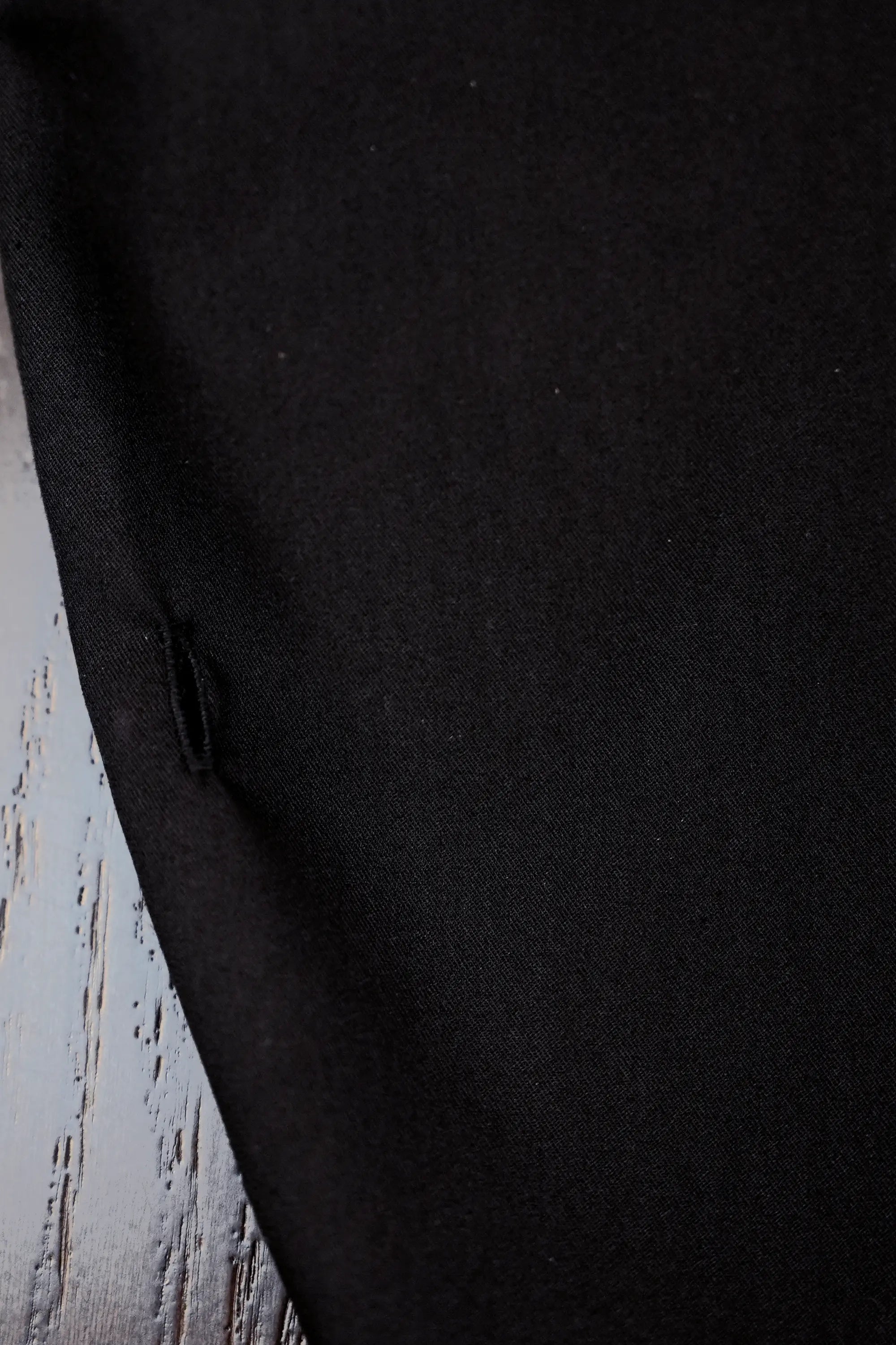 Close-up of buttonhole detail on Arrayed black adjustable top