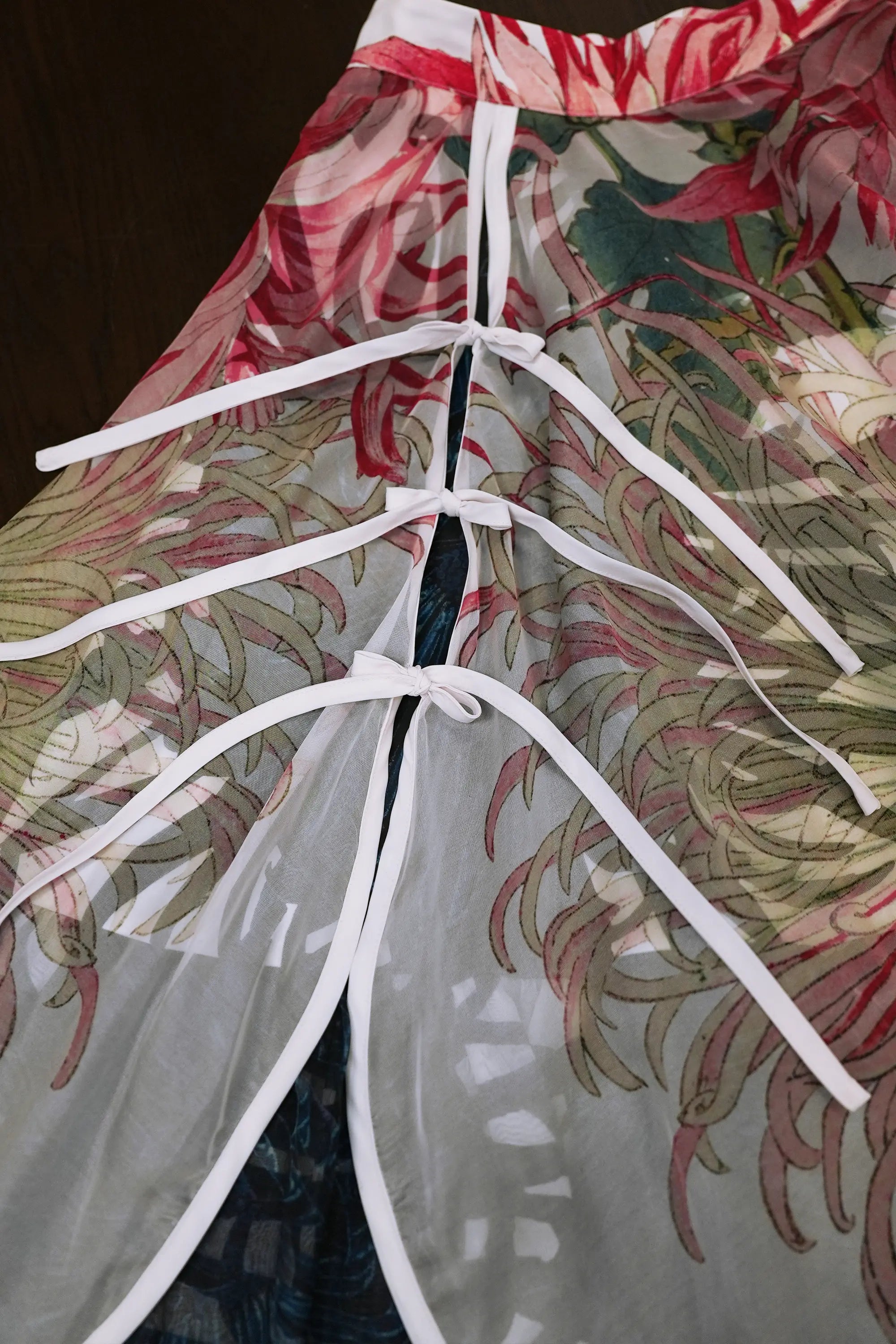 Close-up of ribbon tie closure on Arrayed Chrysanthemum print organza piping skirt