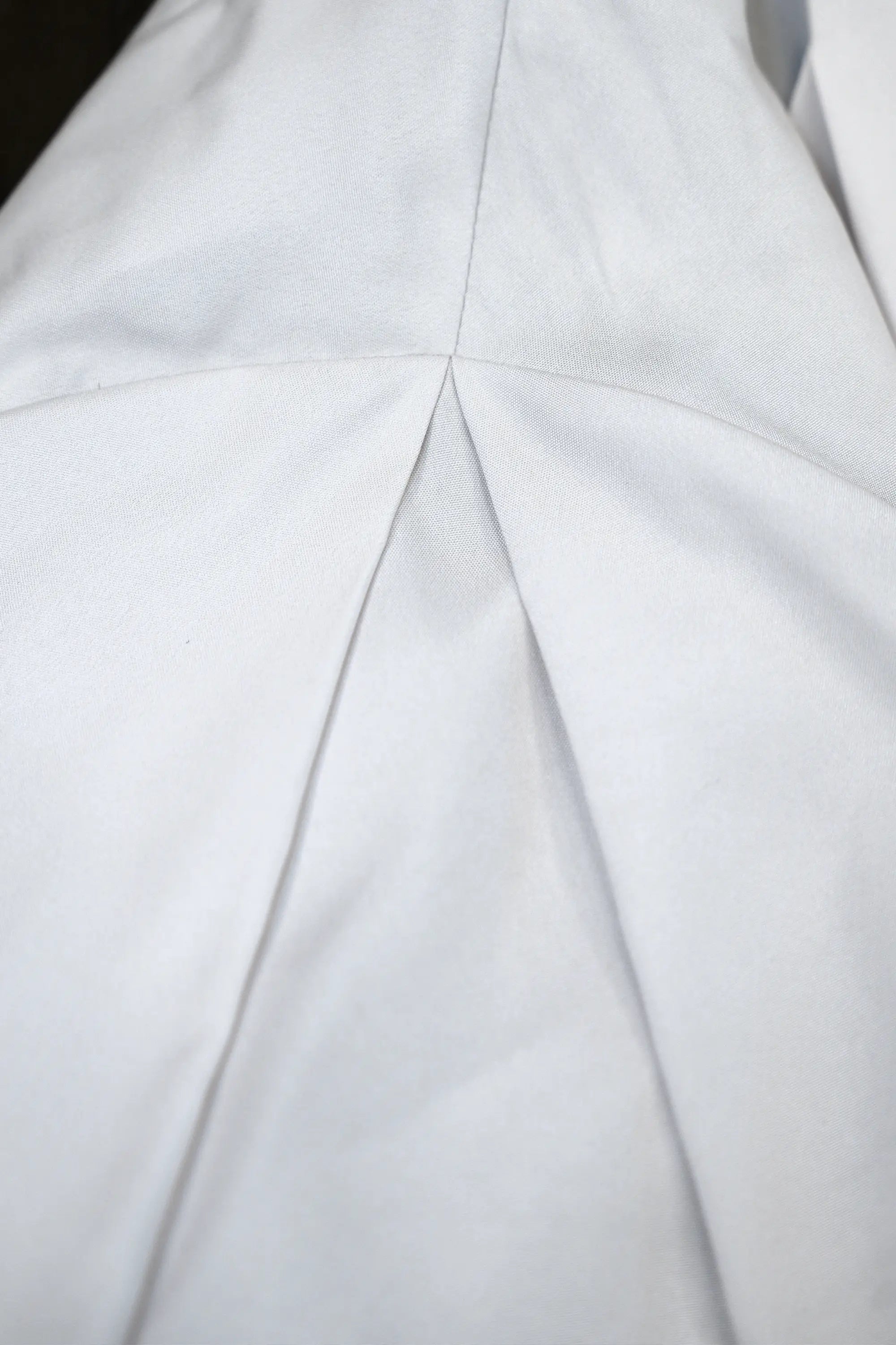 Close-up of calla sleeve pleat on Arrayed Peony wrap dress