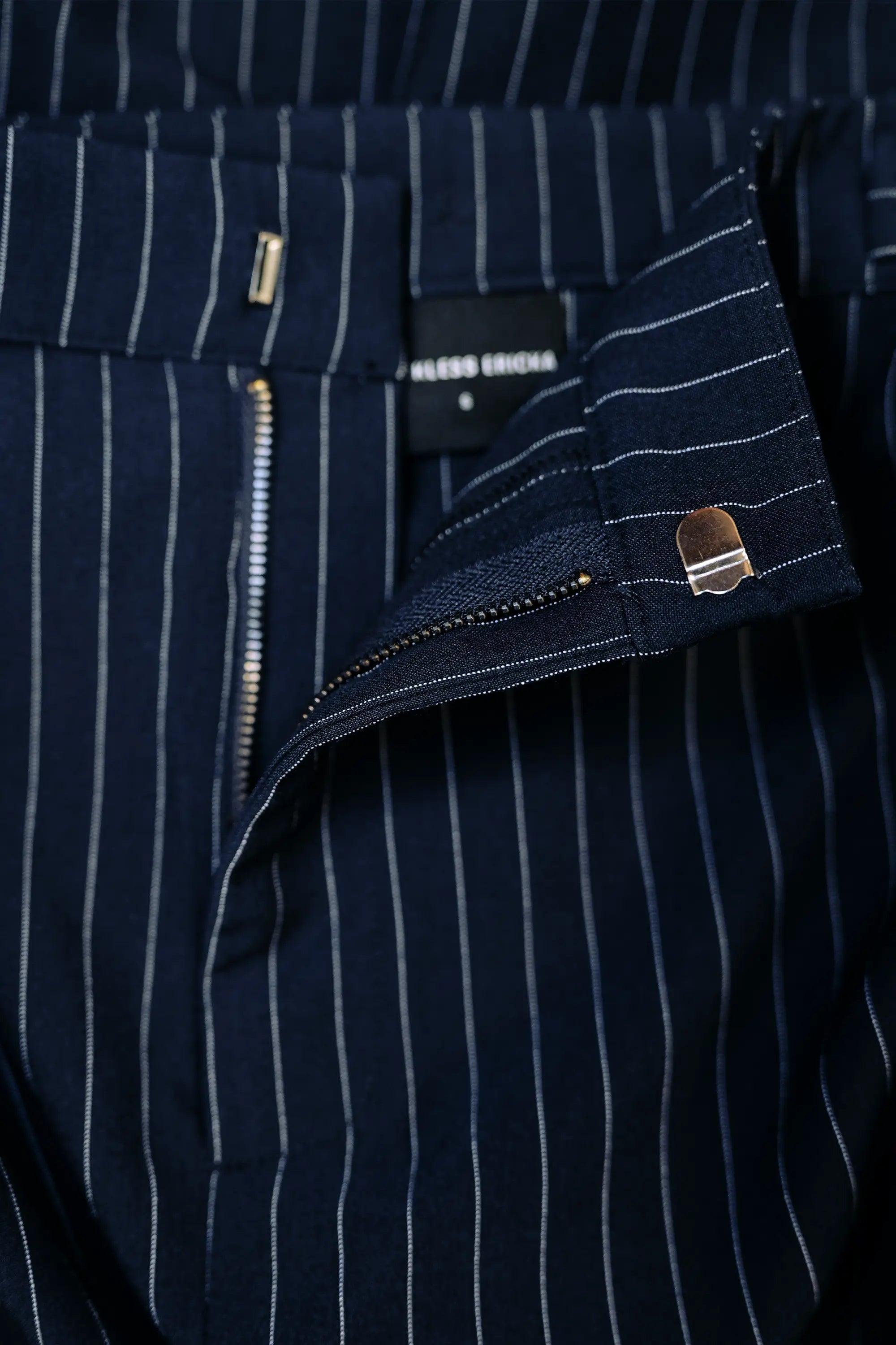 Close-up of zip closure on Arrayed navy pinstripe handkerchief skirt