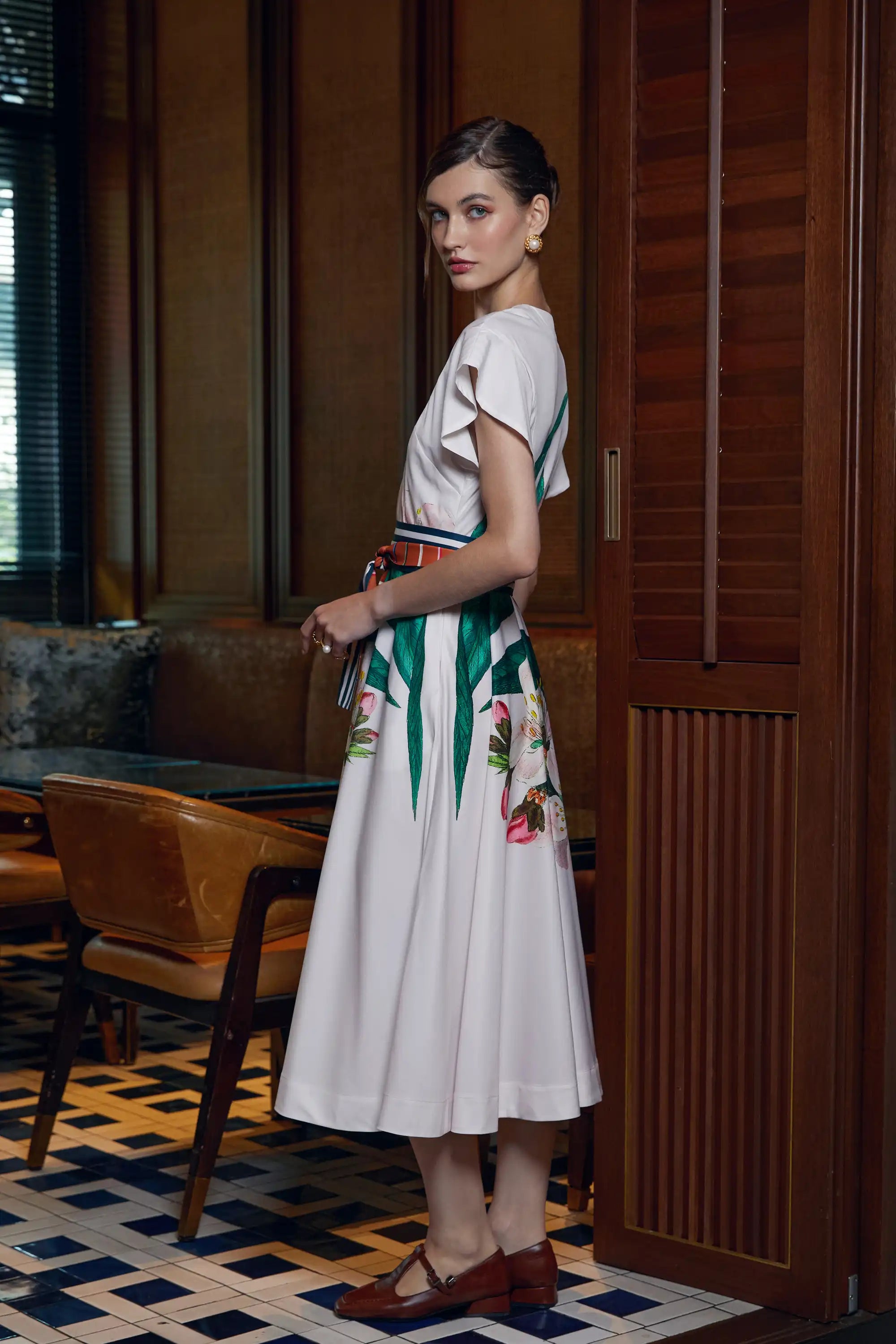 Woman wearing Arrayed ivory Almond print midi dress, side view