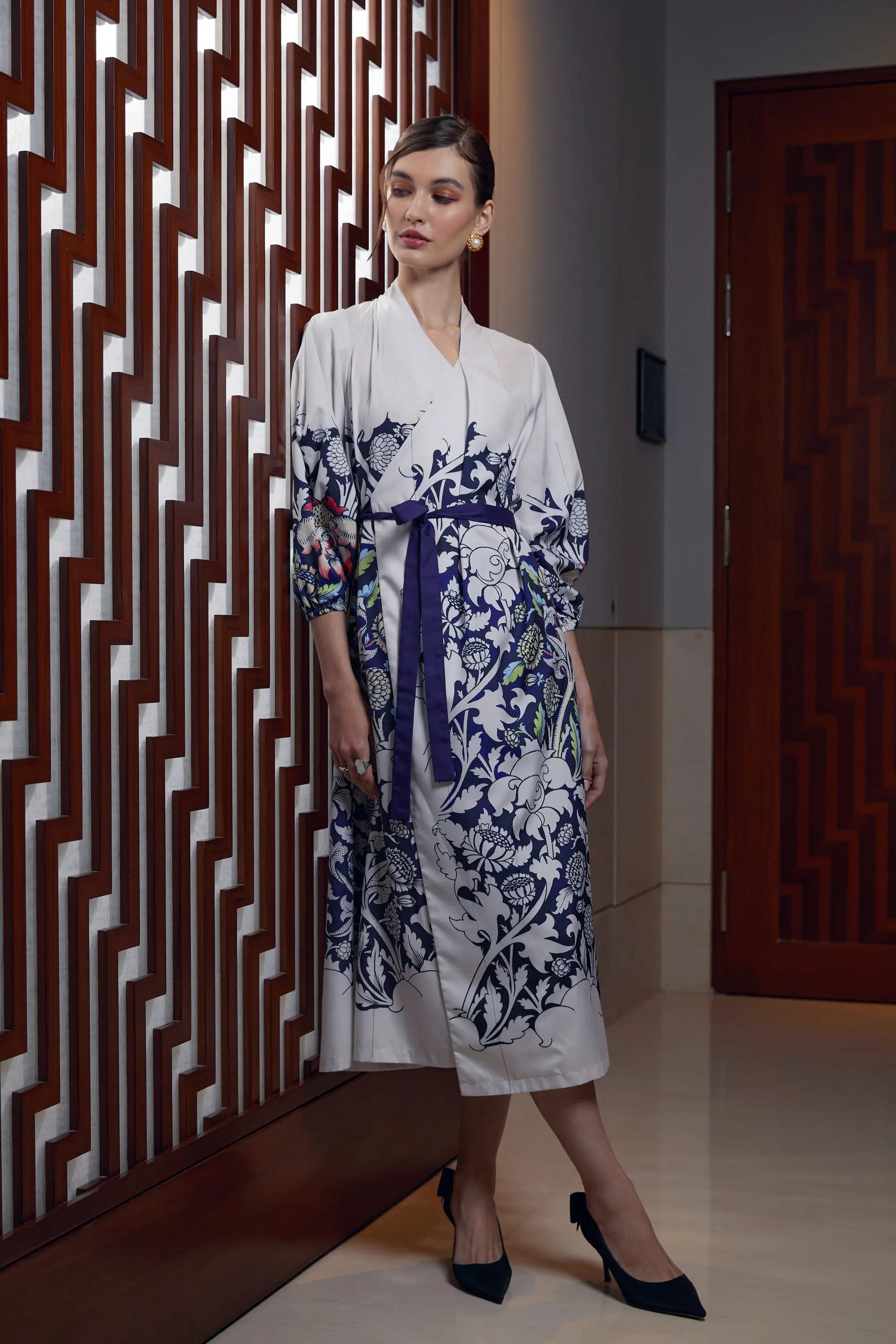 Woman wearing Reckless Ericka Arrayed Peony print calla sleeve wrap dress in ivory, front view