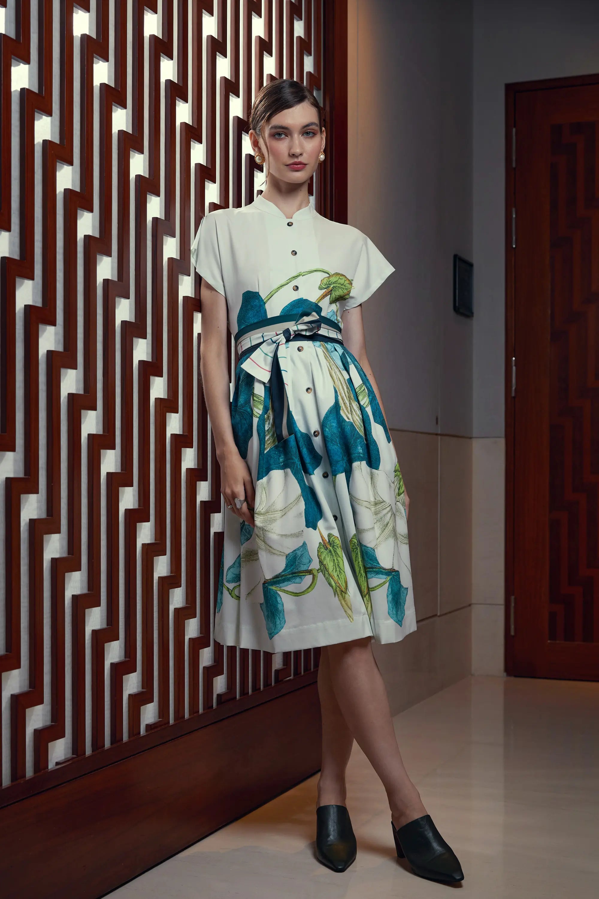 Woman wearing Reckless Ericka Arrayed Bindweed print Chinese collar fit-and-flare dress in ivory, front view